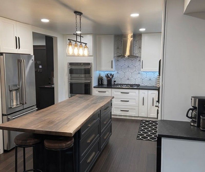 A kitchen with a large island in the middle of it.