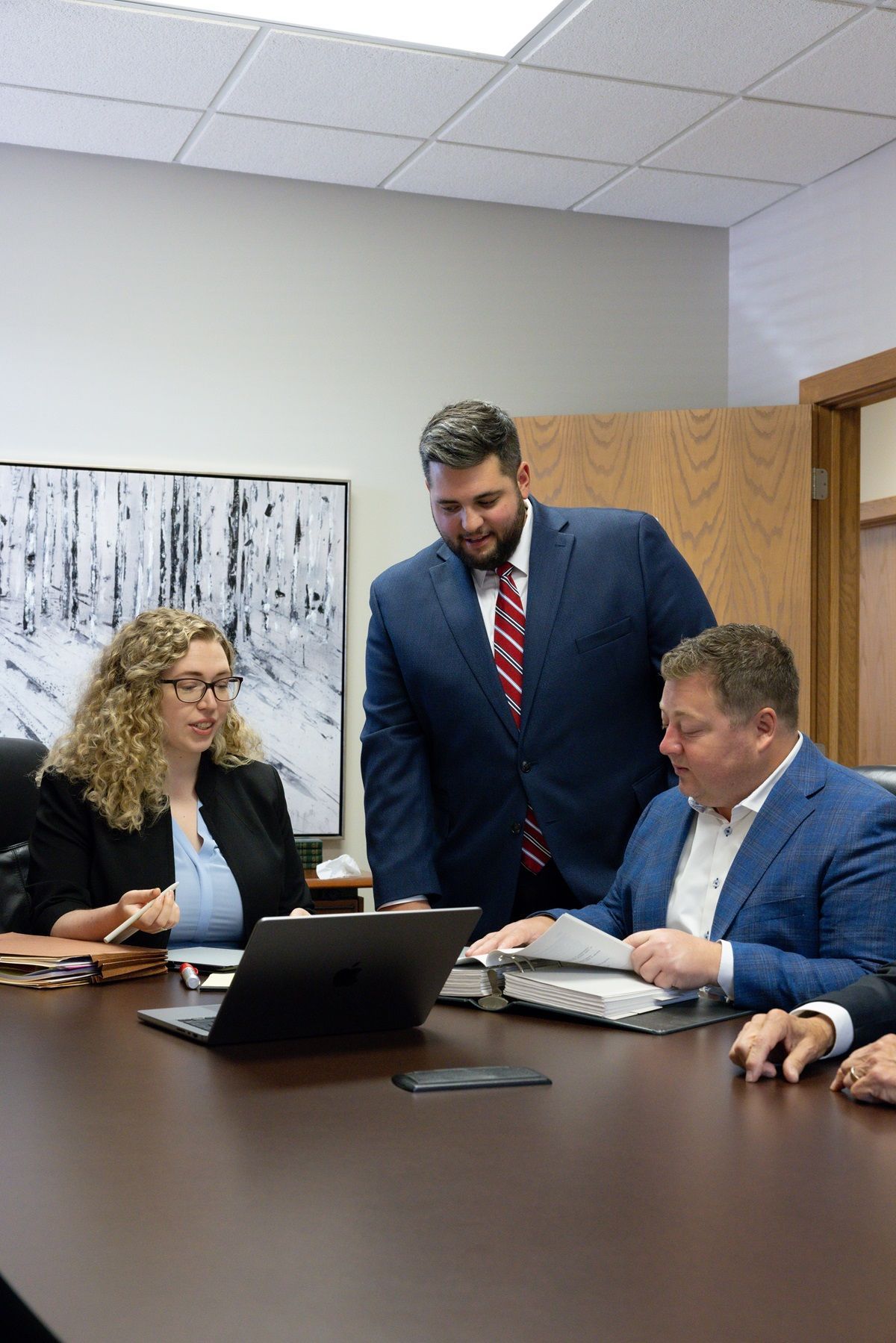LLDDC Law personal injury attorneys collaborating on an injury case in a conference room.