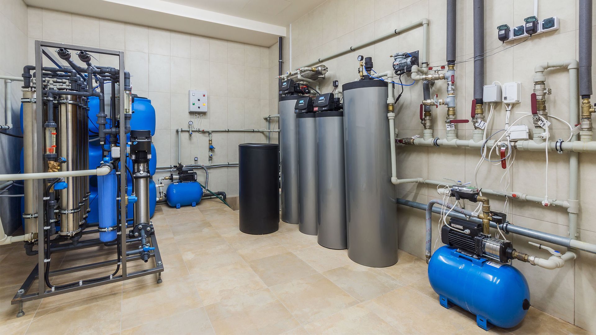 Three white Perron Plumbing vans parked in a cracked lot.