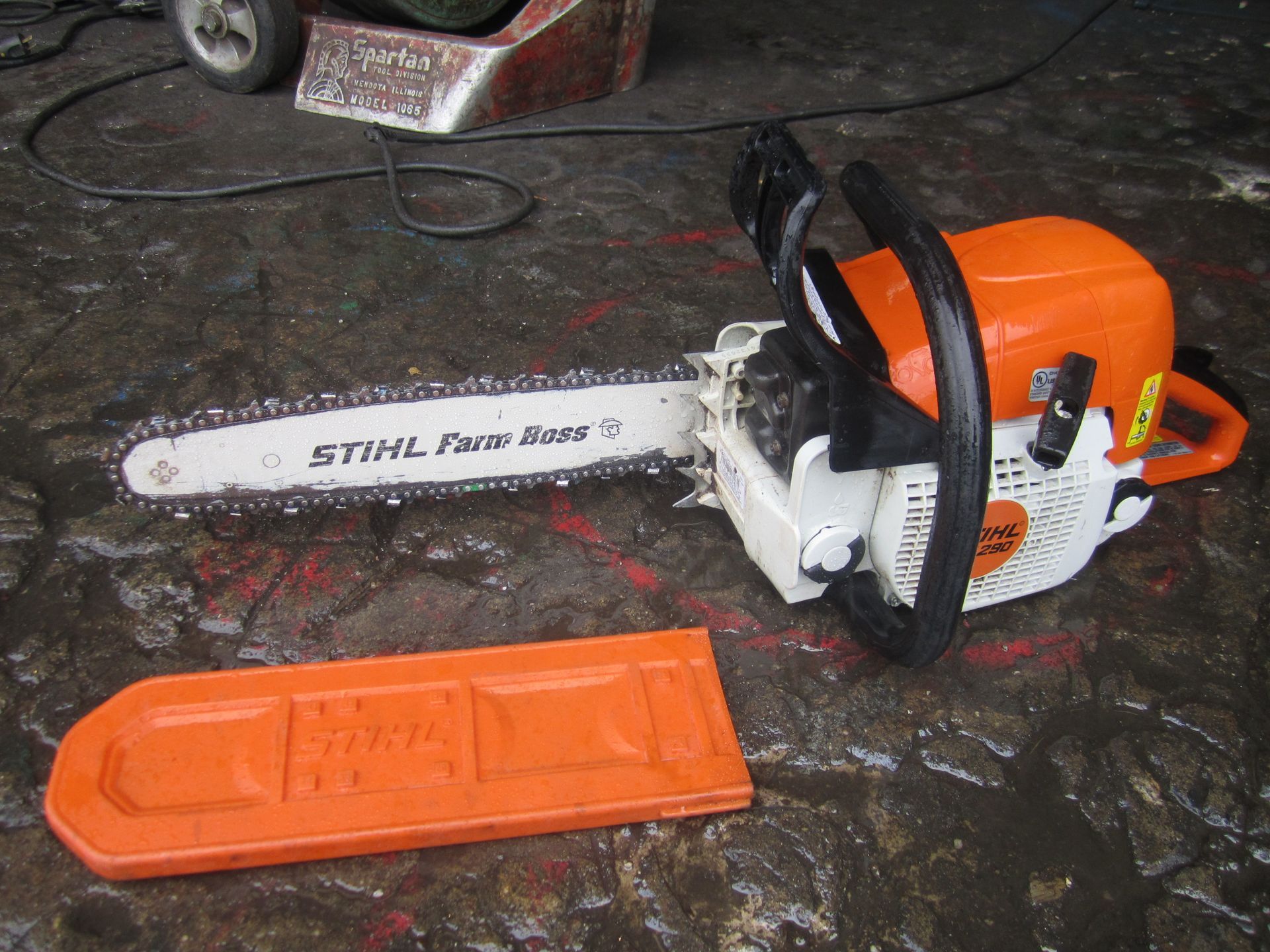 A stihl chainsaw is sitting on the ground