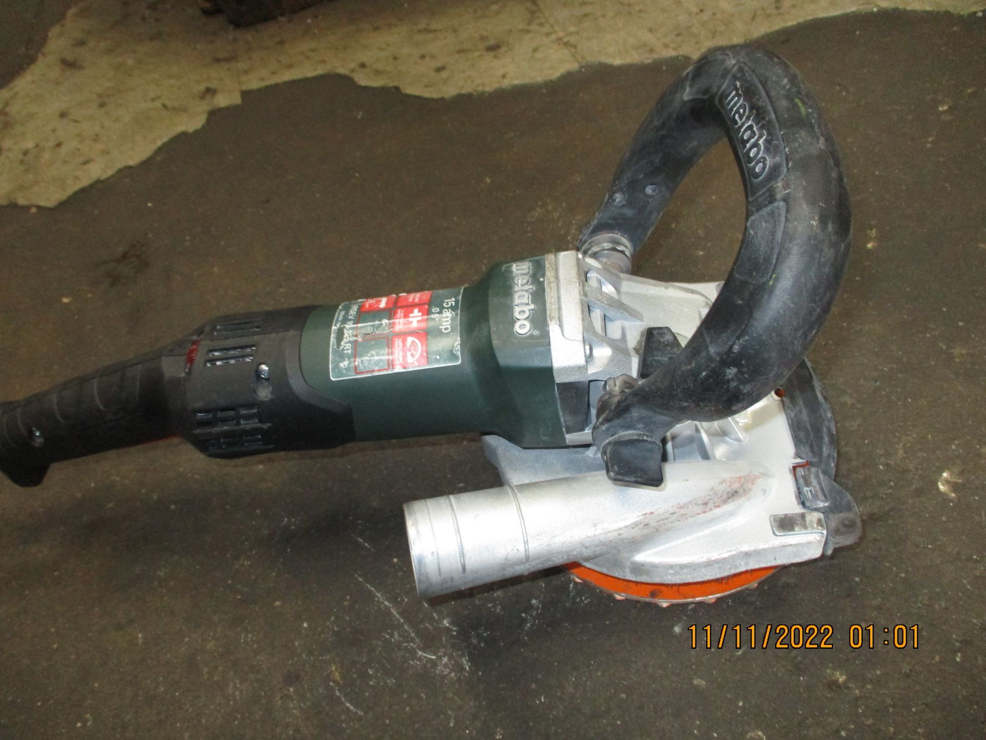 A metabo grinder is laying on the ground