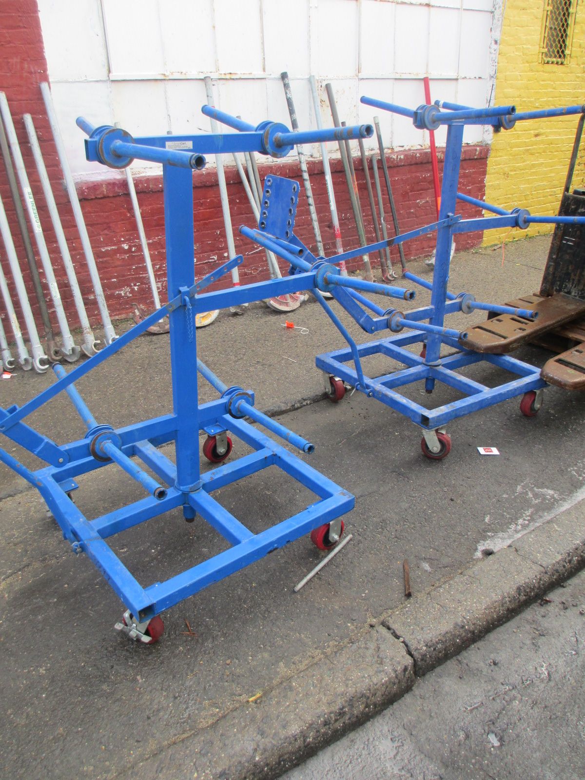 Two blue carts are parked on the side of the road