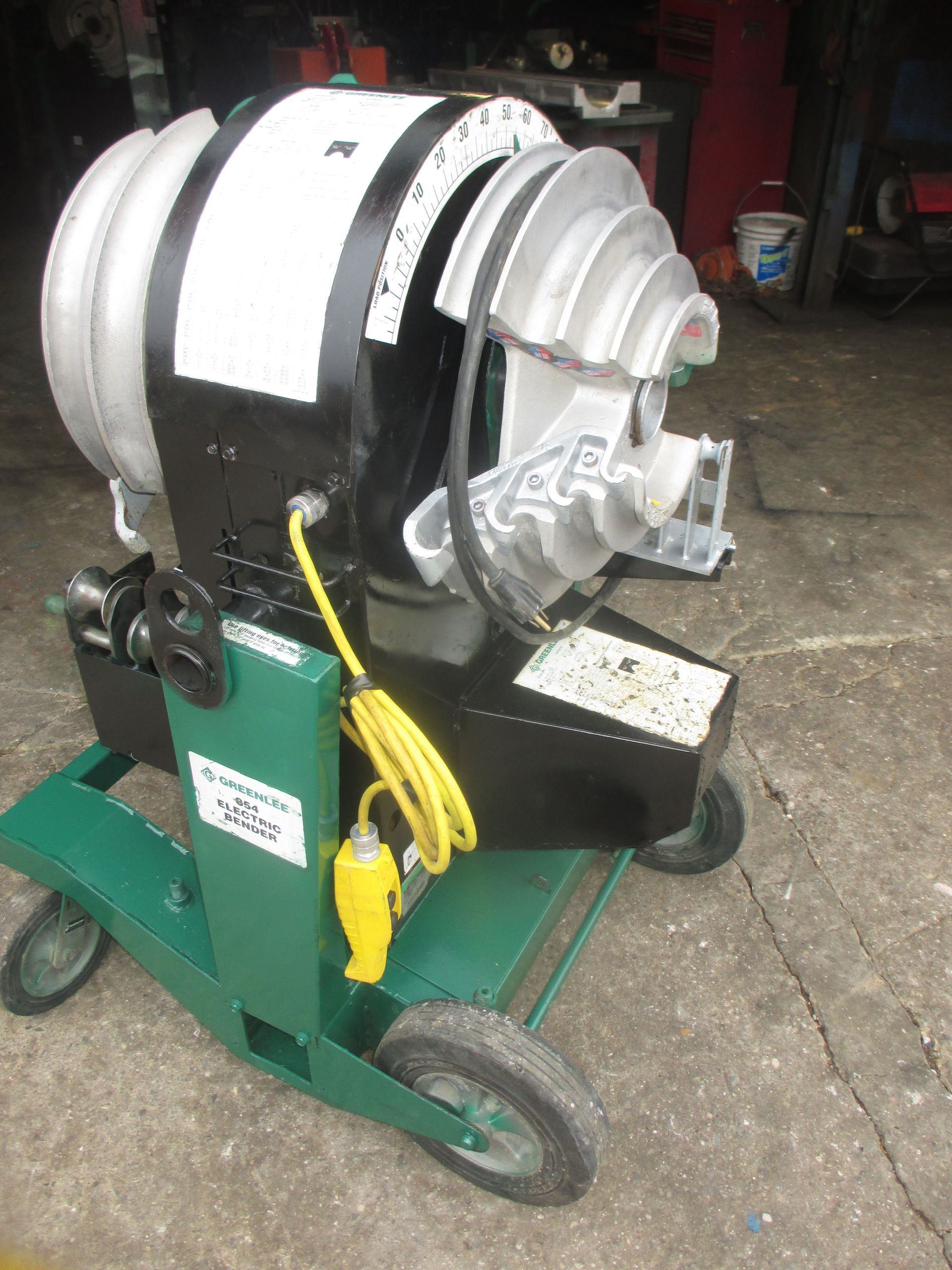 A machine with a hose attached to it is sitting on a cart.