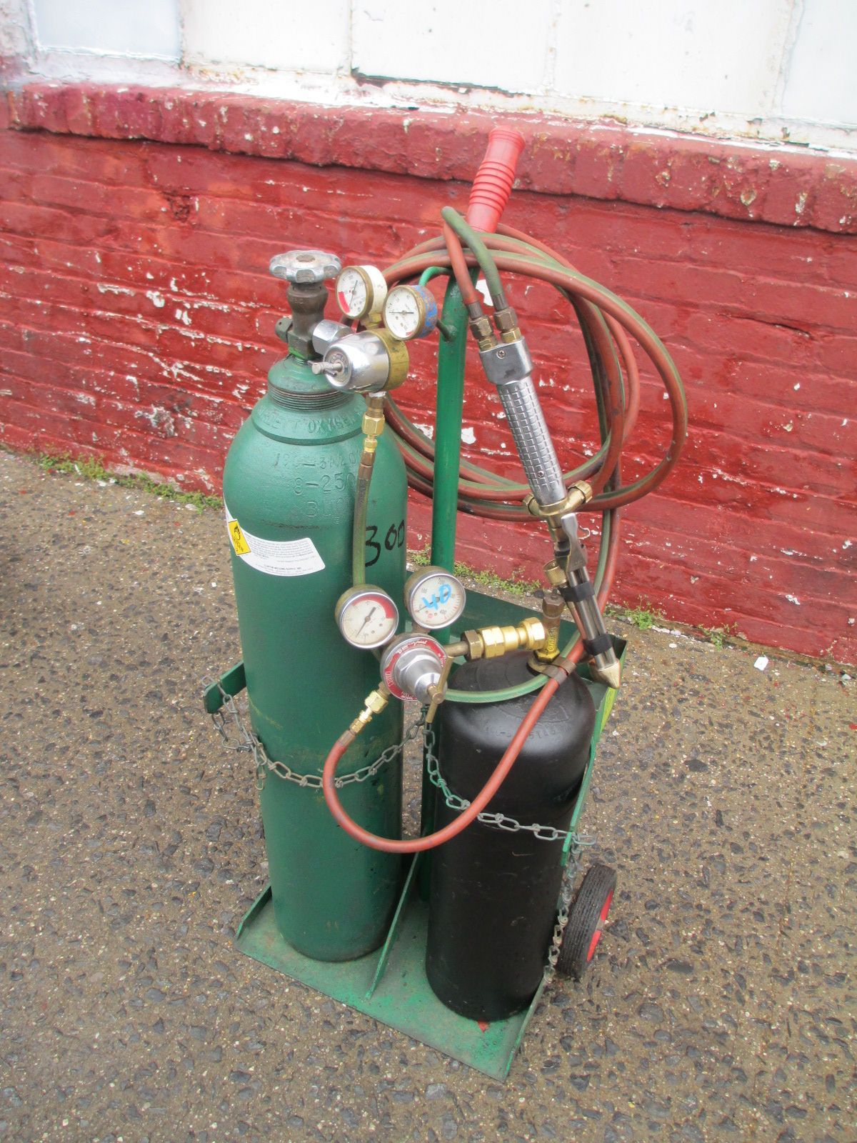 A cart with two gas cylinders attached to it