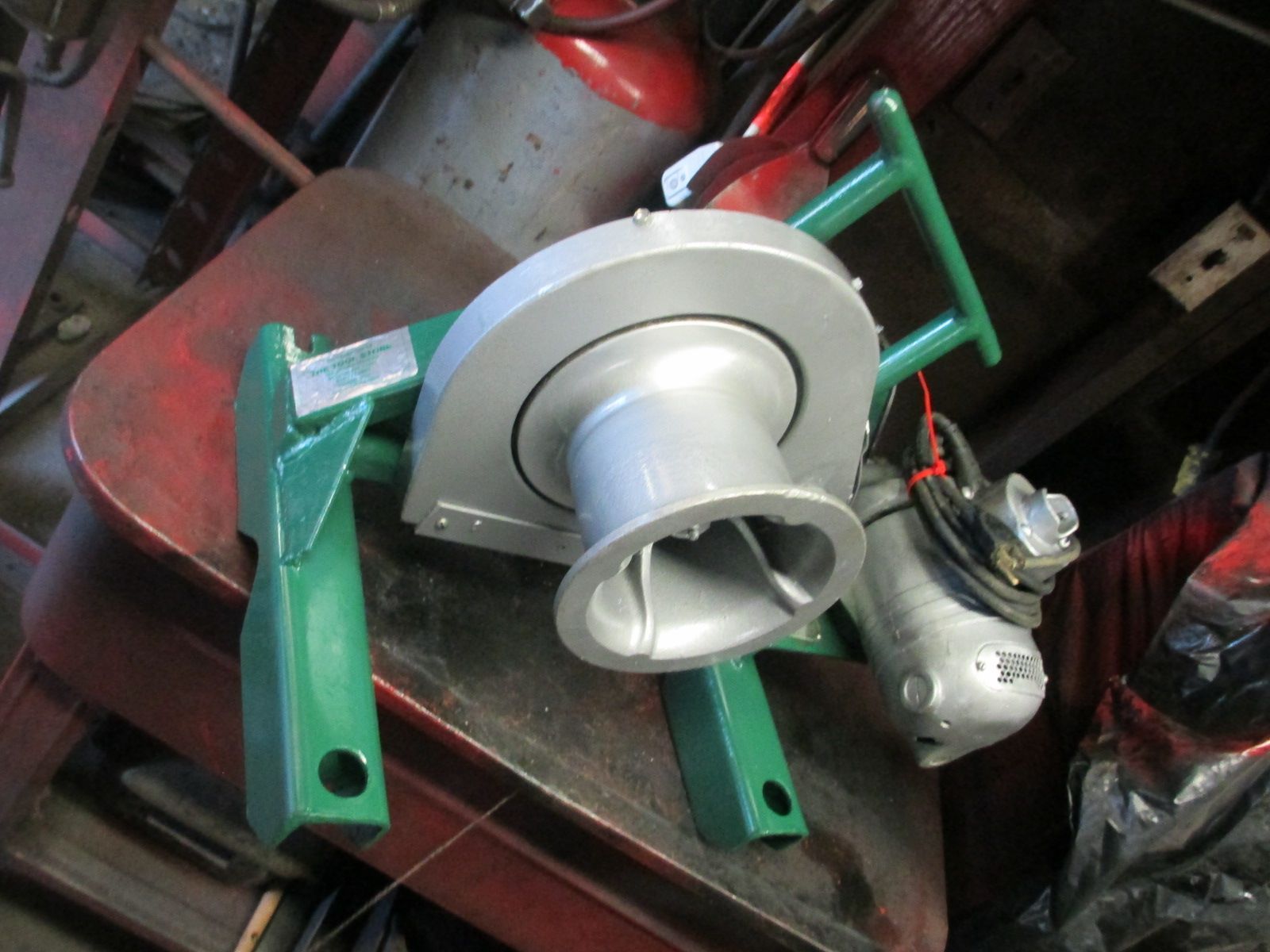 A machine with a green handle is sitting on a table