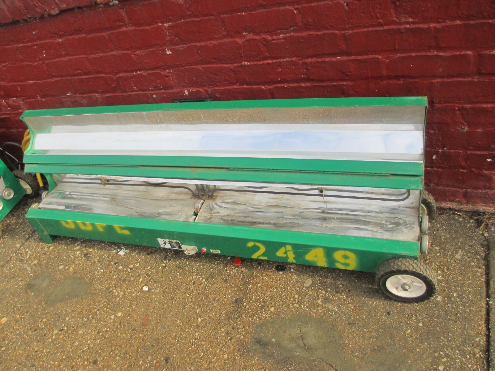 A green bench with the number 2499 painted on it