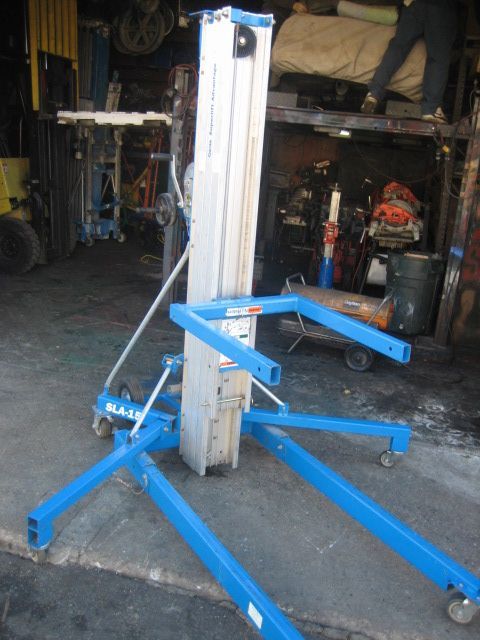 A blue and white machine is sitting in a garage