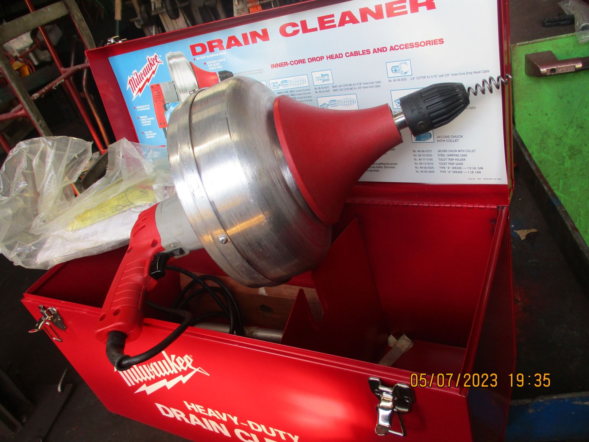 A red box with a drain cleaner inside of it