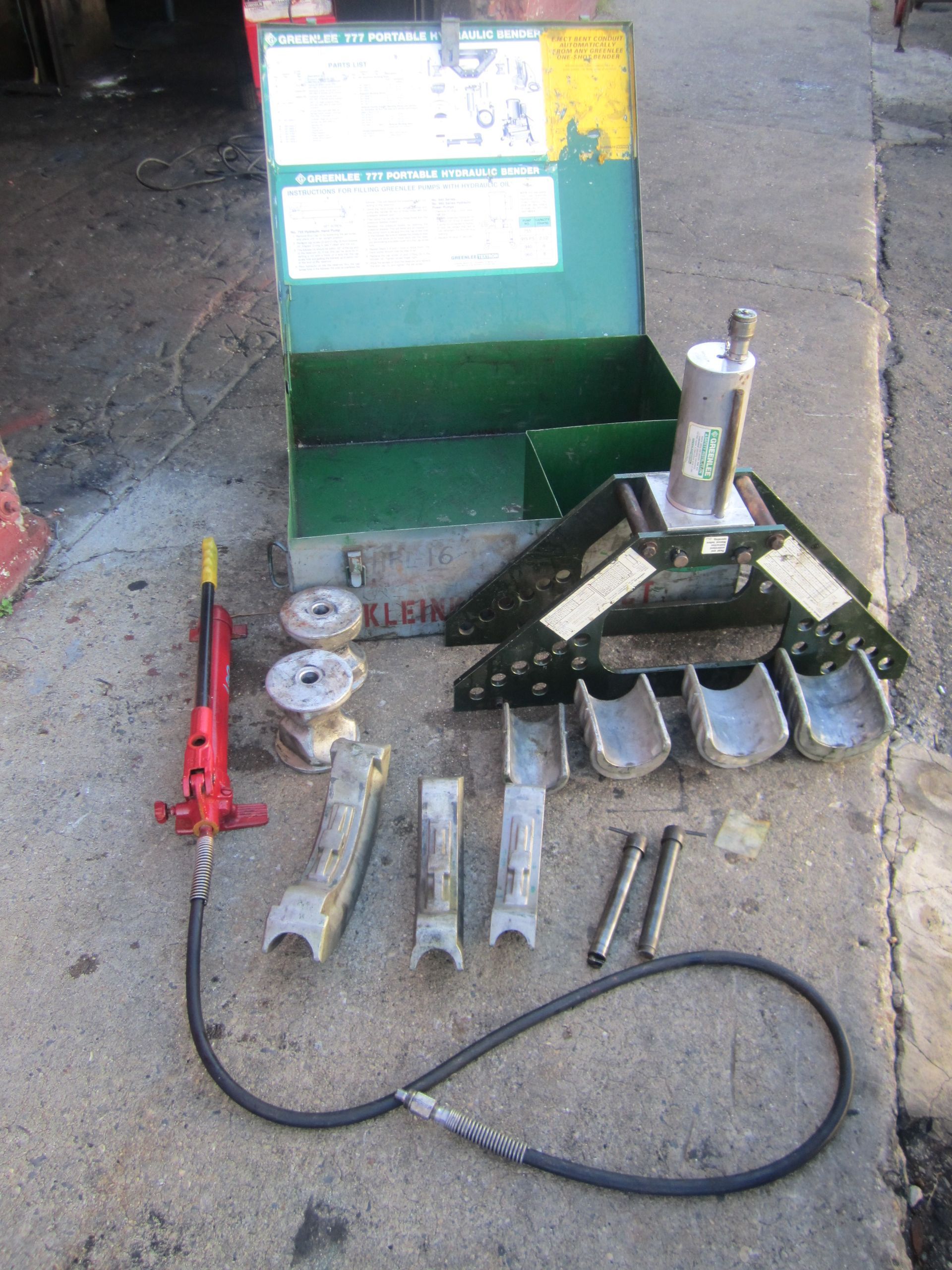 A green box with a bunch of tools inside of it