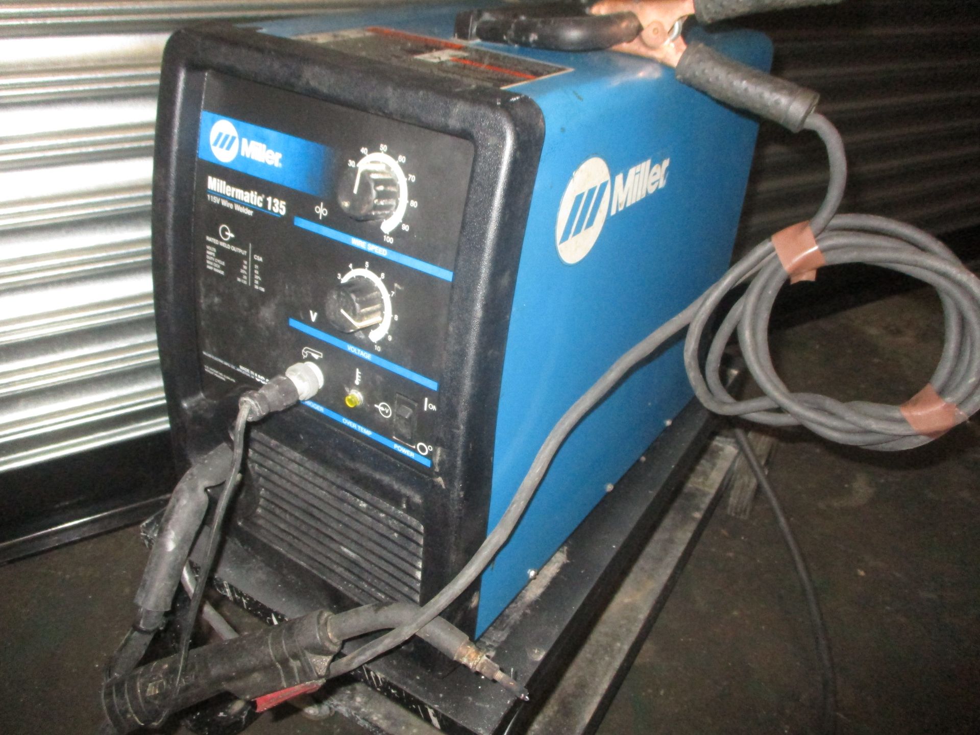 A miller welding machine is sitting on a cart