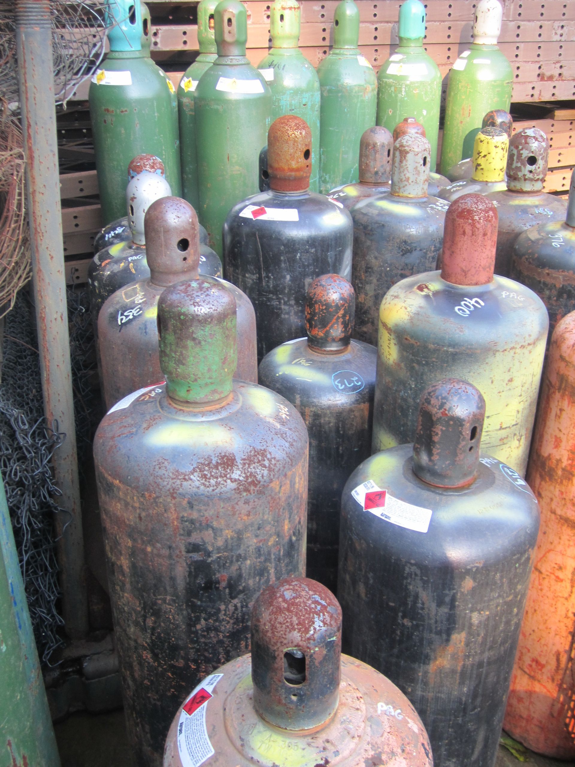 A bunch of gas cylinders are stacked on top of each other
