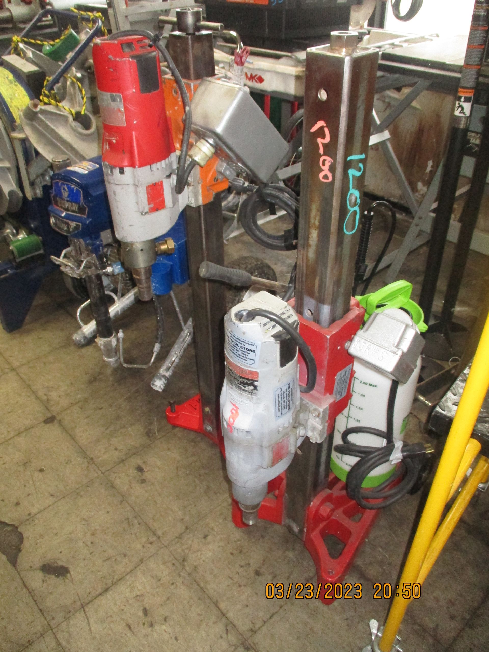 A bunch of tools are sitting on a tiled floor