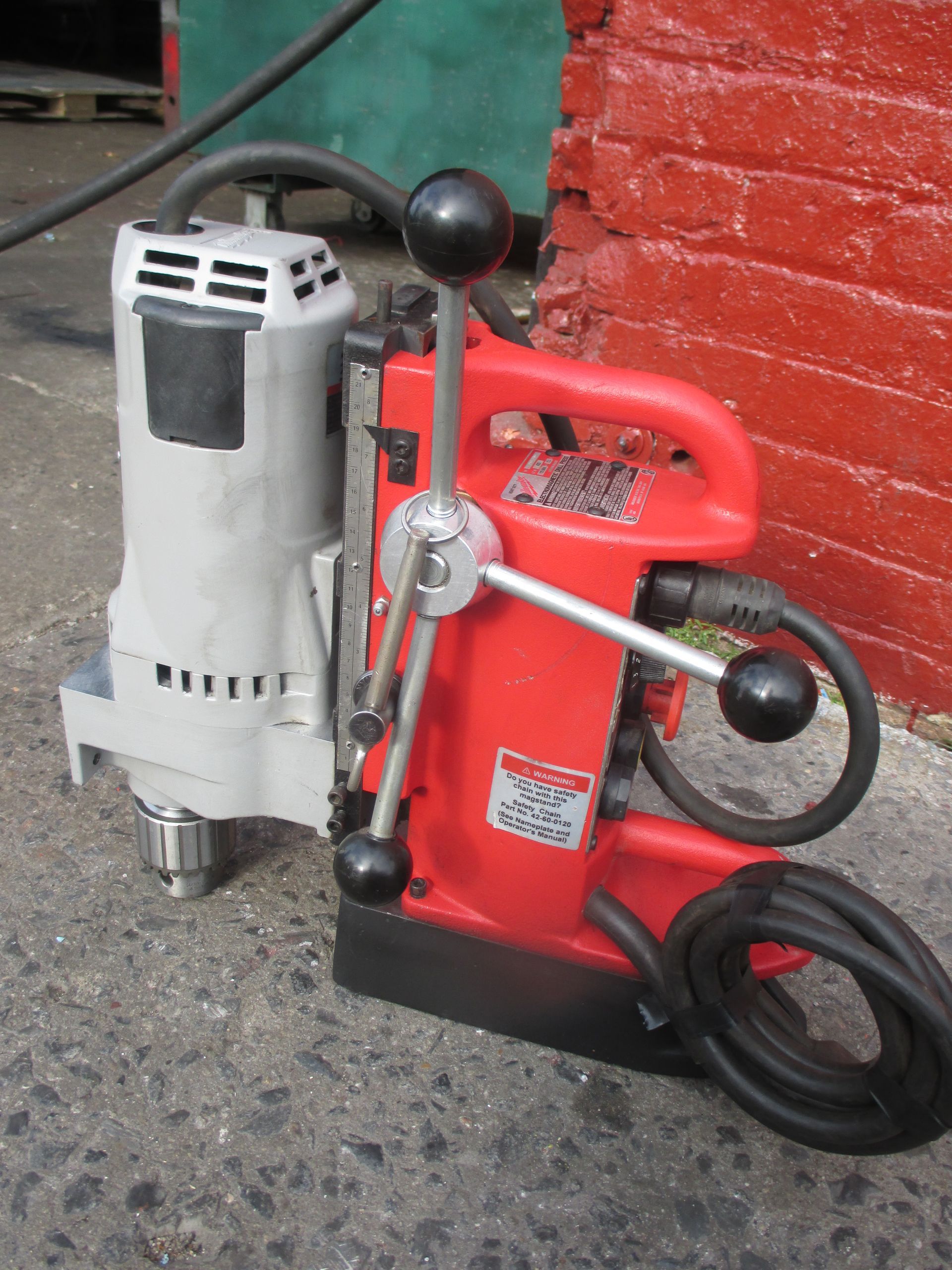 A red and white machine with a warning label on it