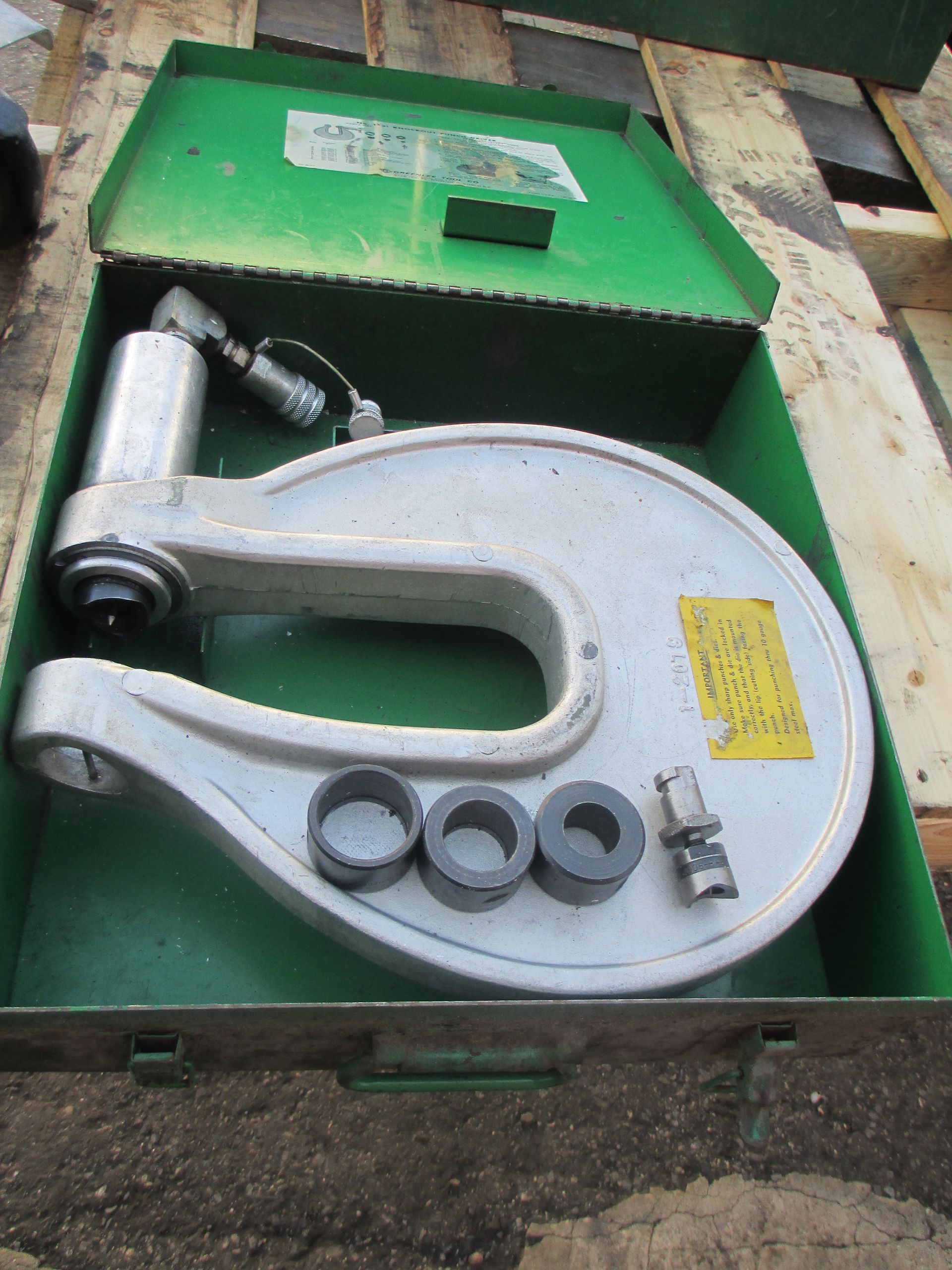 A green box with a tool inside of it