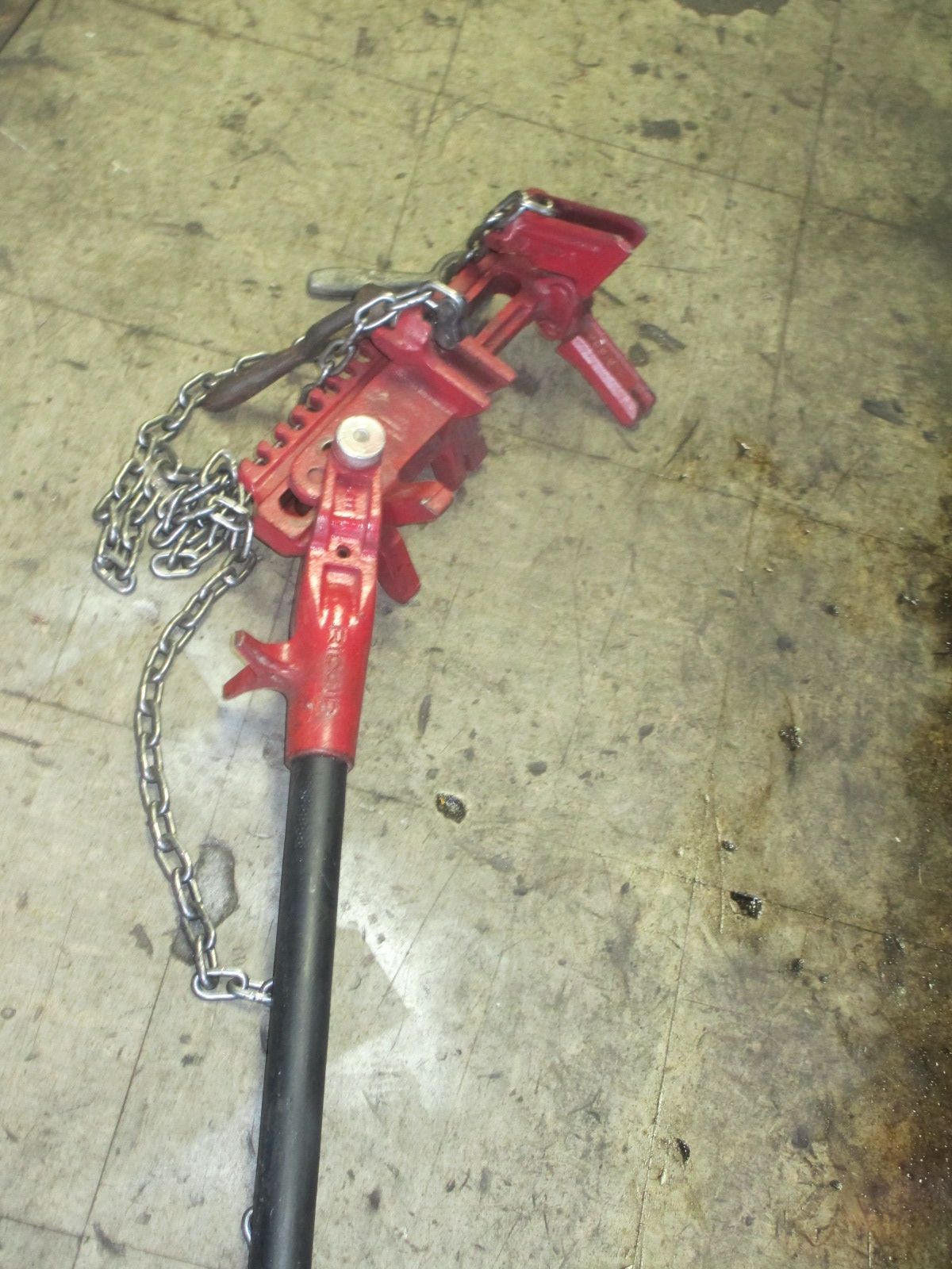 A red tool with a chain attached to it