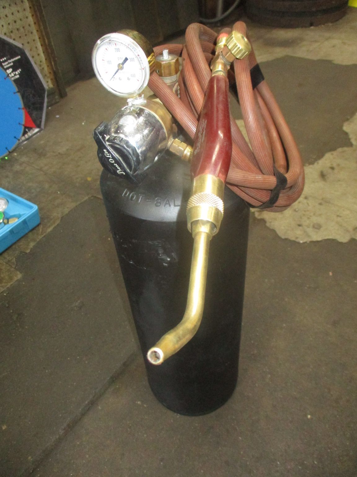 A black cylinder with a hose attached to it