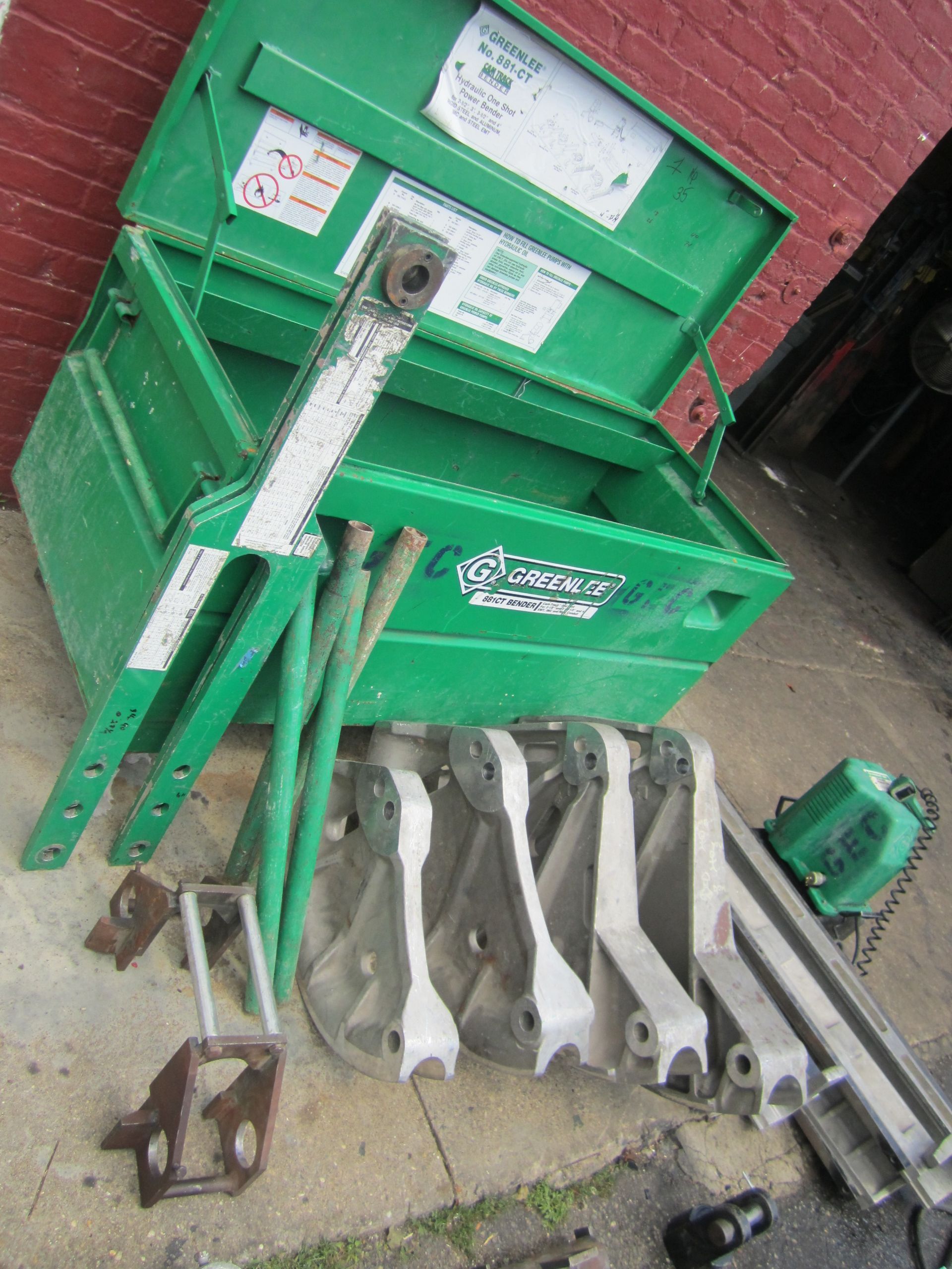 A green box with a lot of tools inside of it