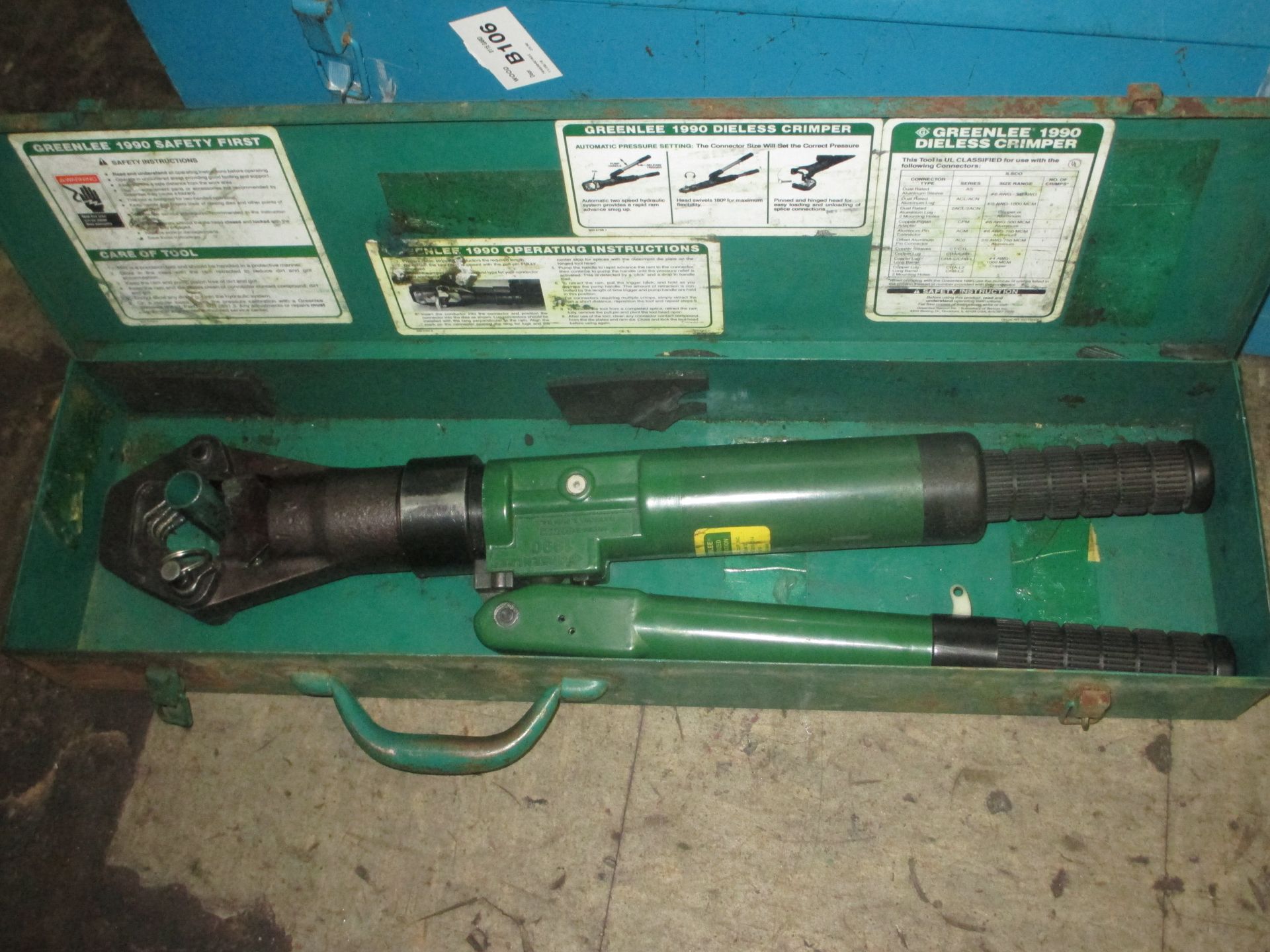 A green tool is in a green case with instructions on it