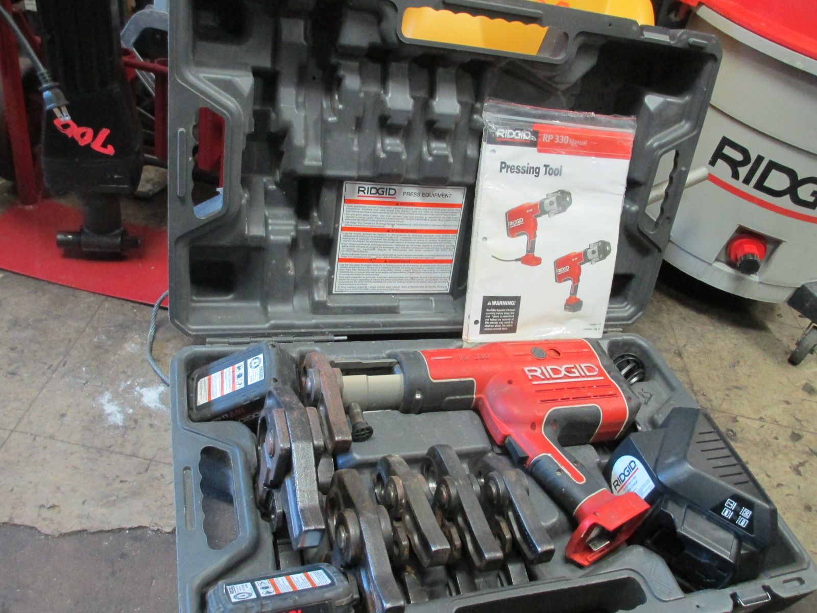 A tool box with a ridge vacuum in the background