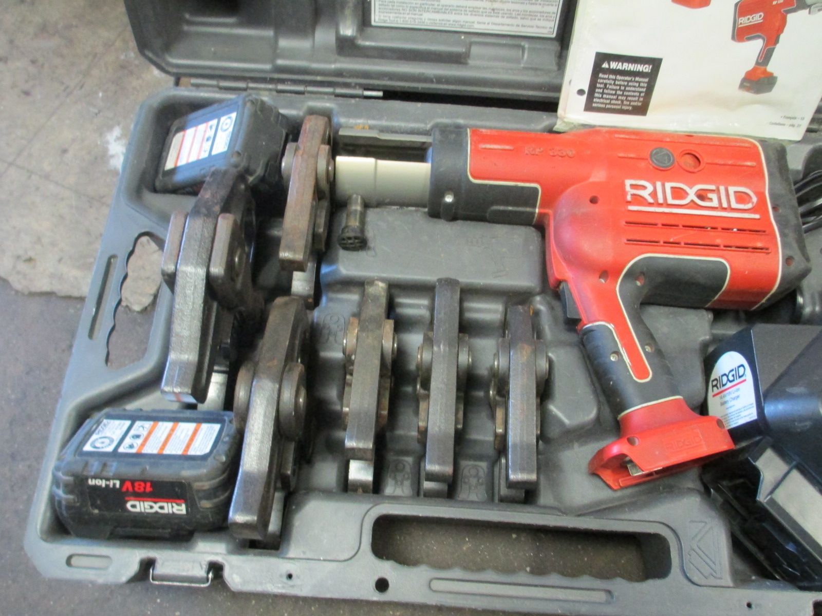 A red ridgid tool is sitting in a case