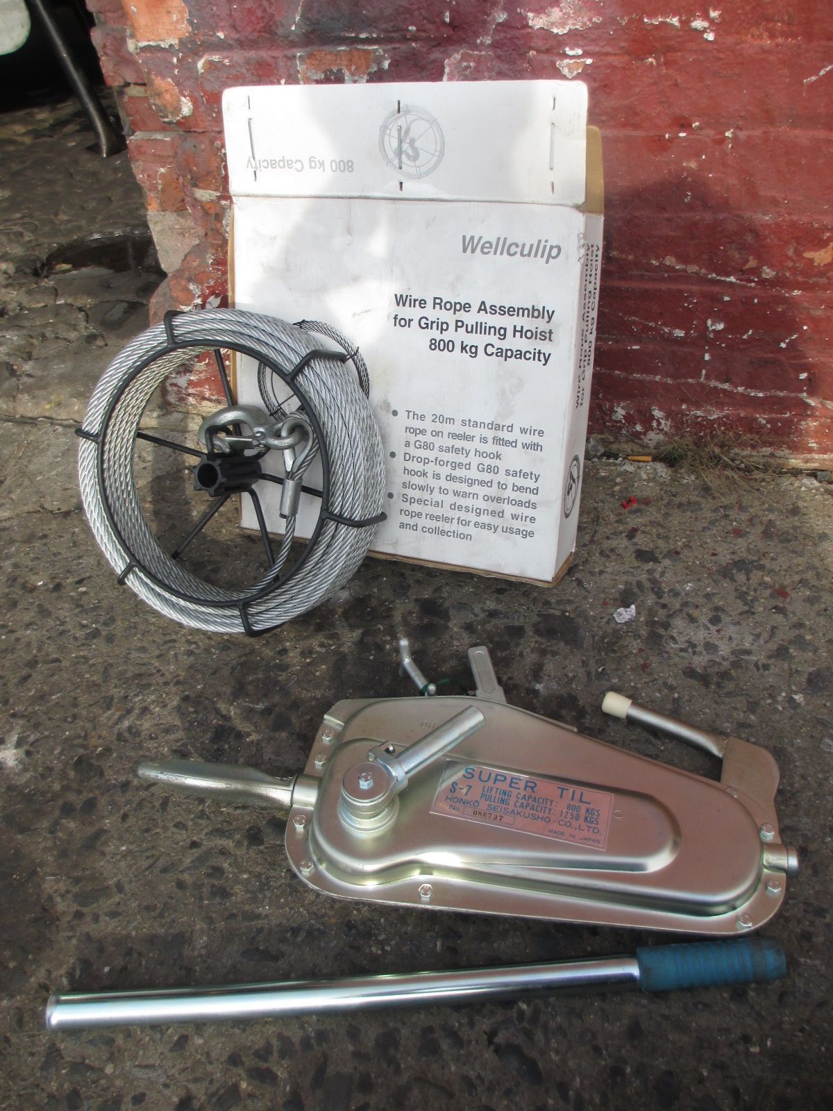 A box with a rope and a tool next to it