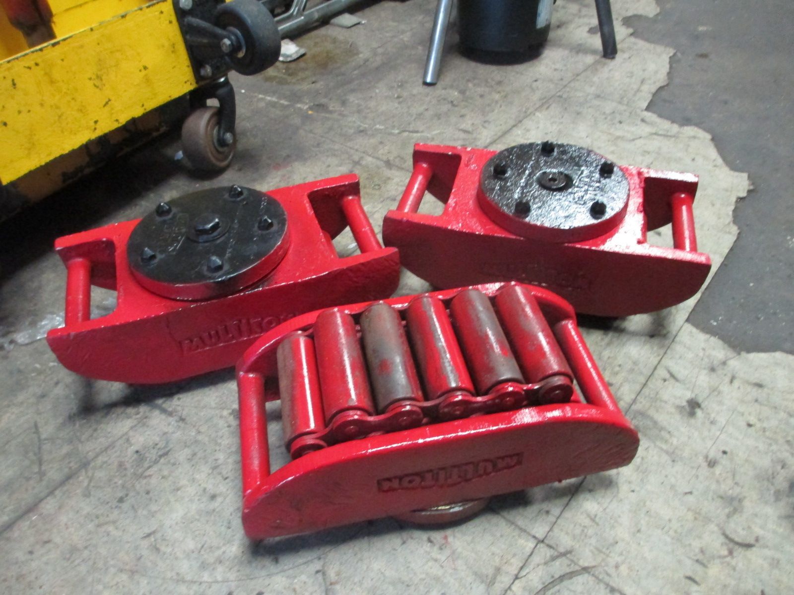 A pair of red heavy duty rollers that say ' heavy duty ' on them
