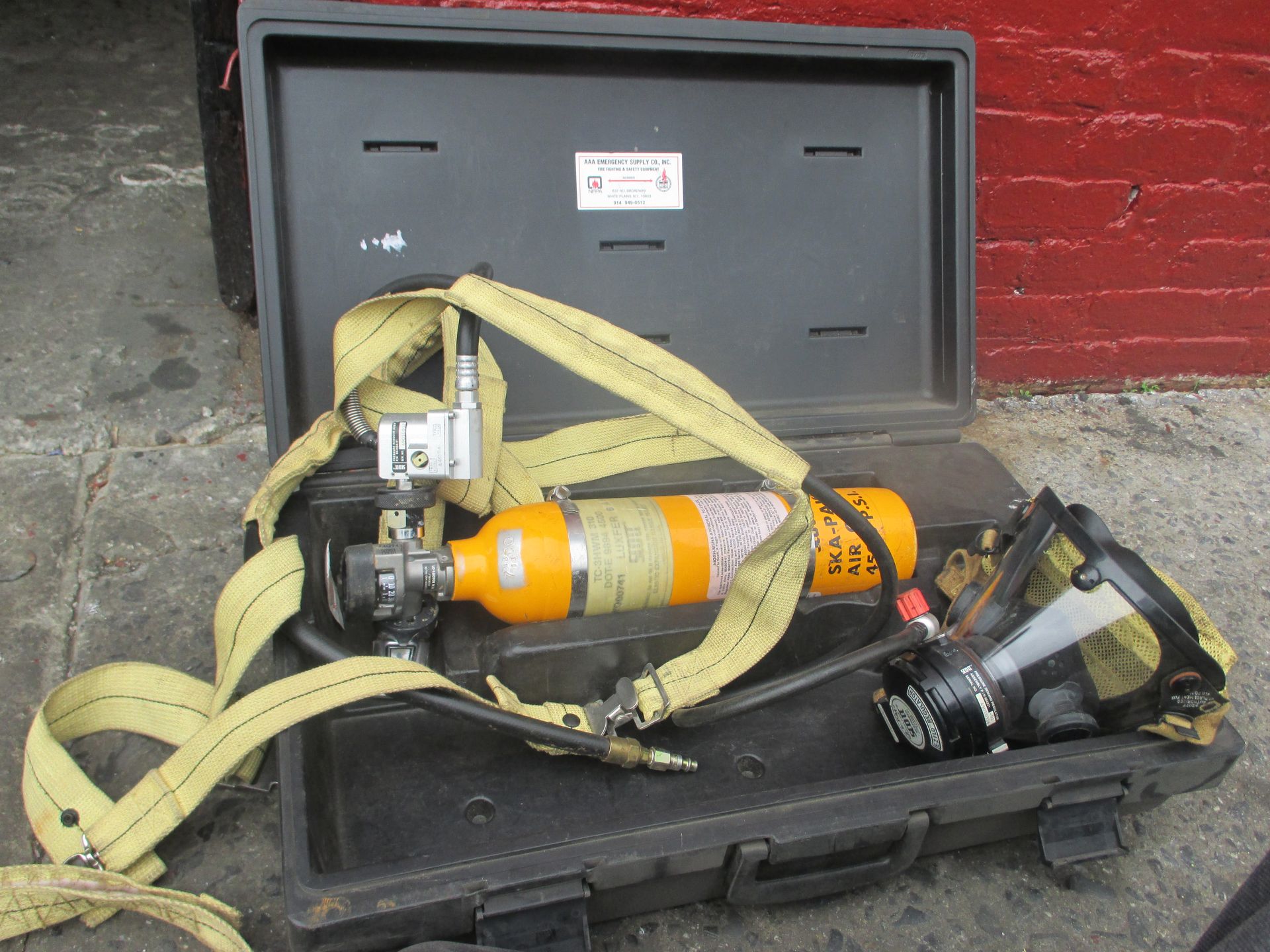 A black case with a hose and a cylinder inside of it