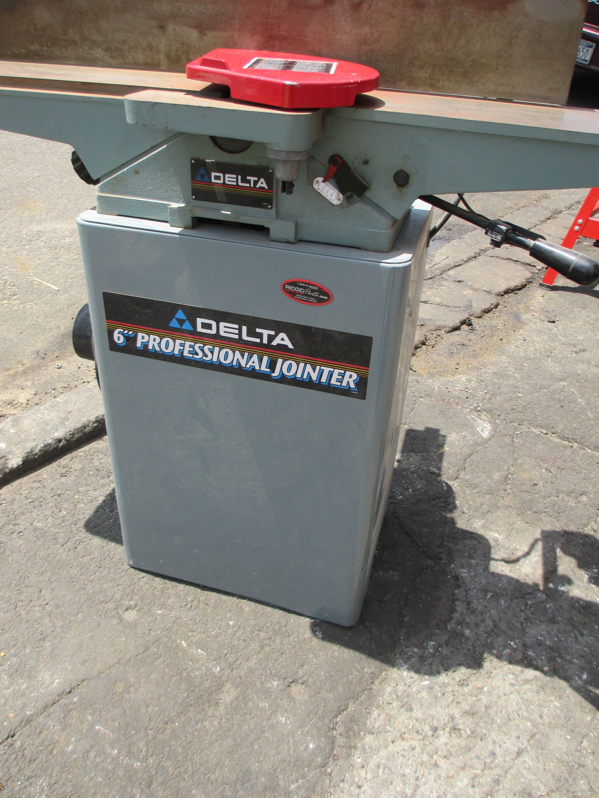 A delta professional jointer is sitting on the ground