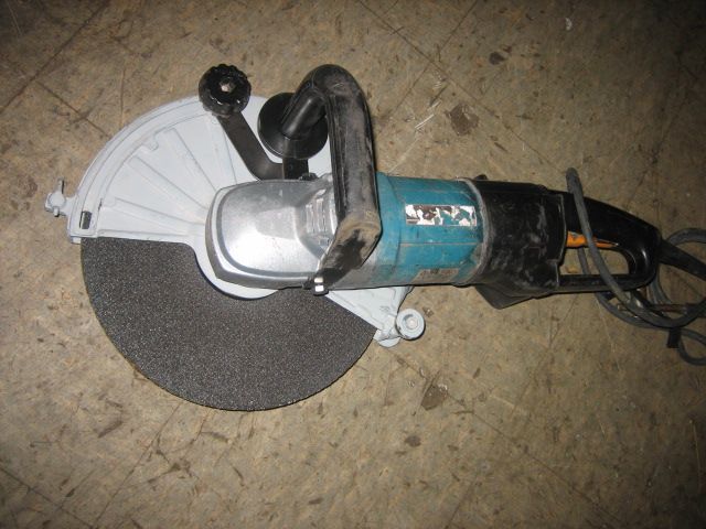 A makita circular saw is sitting on the floor