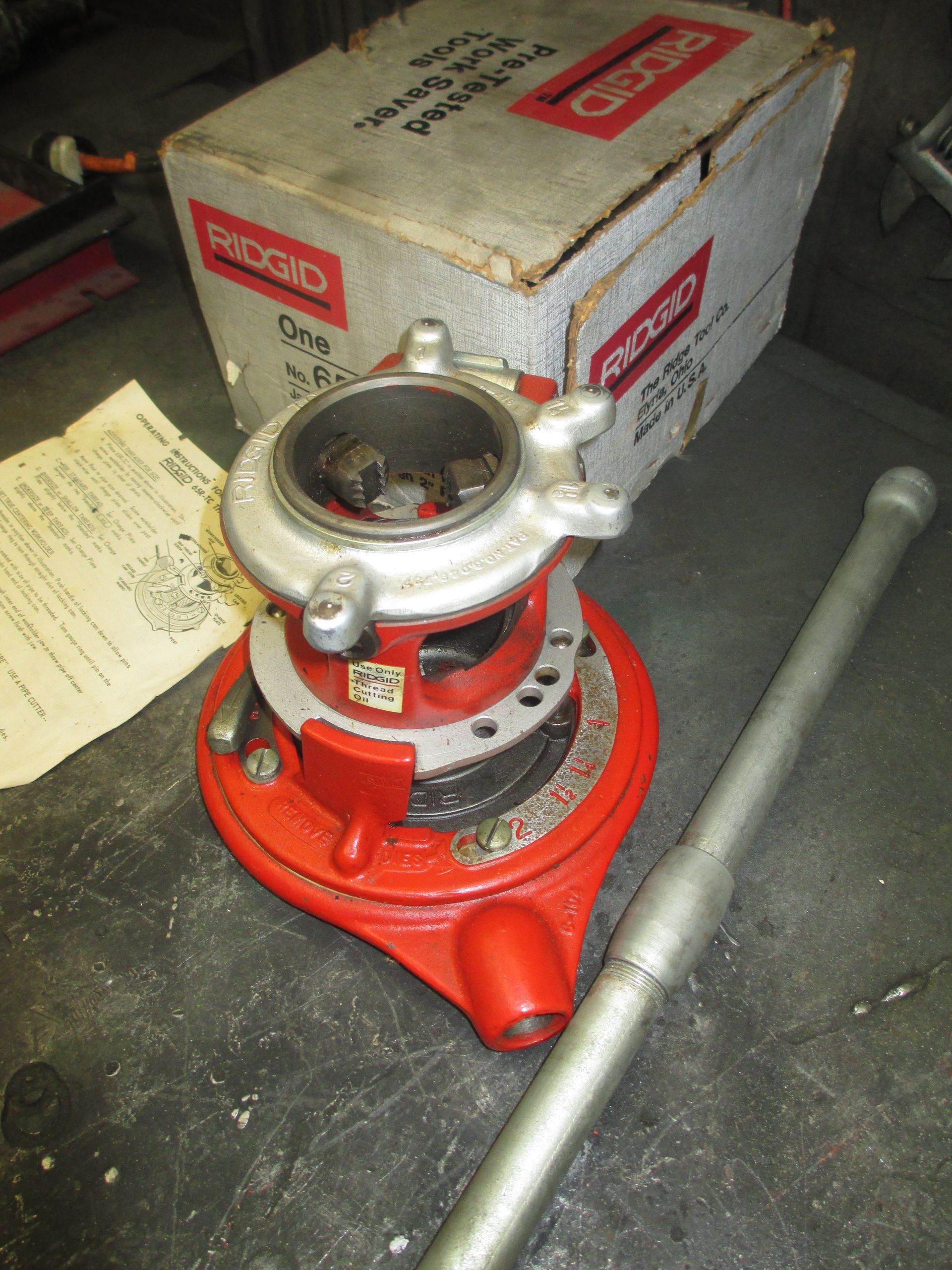 A red tool sits next to a box that says ridgid on it