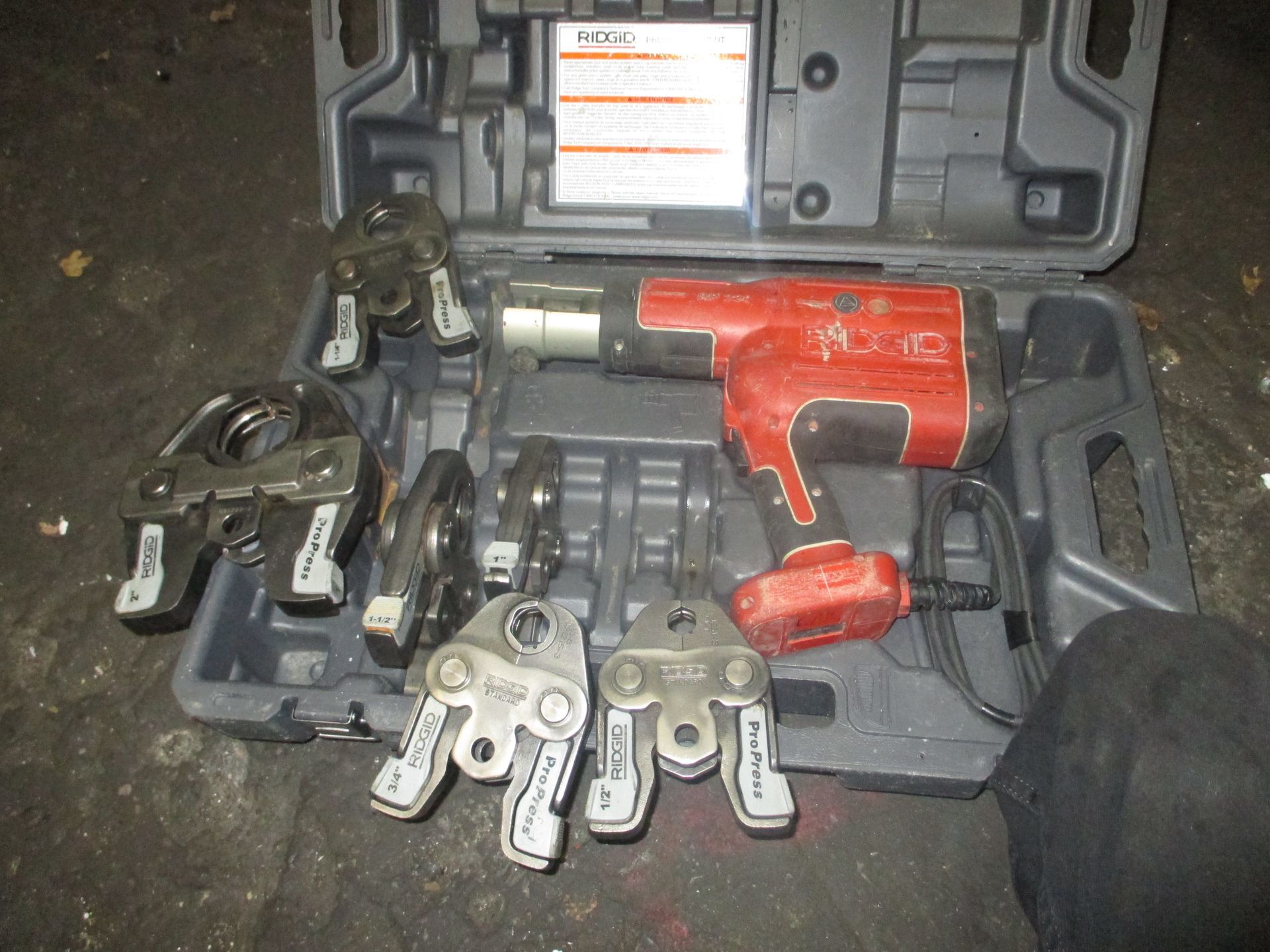 A tool box filled with a bunch of tools and a drill.