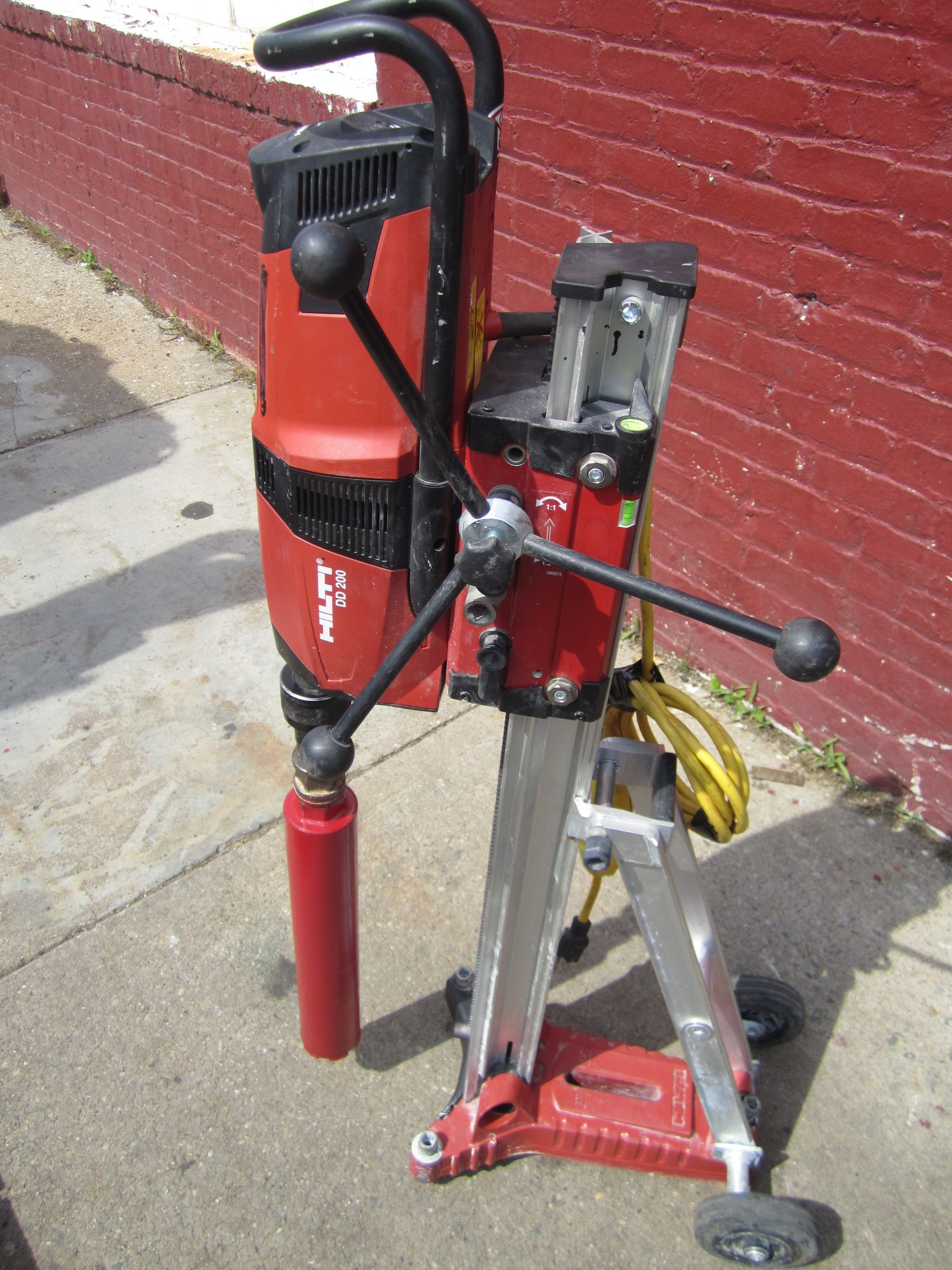 A red drill with the word hilti on it