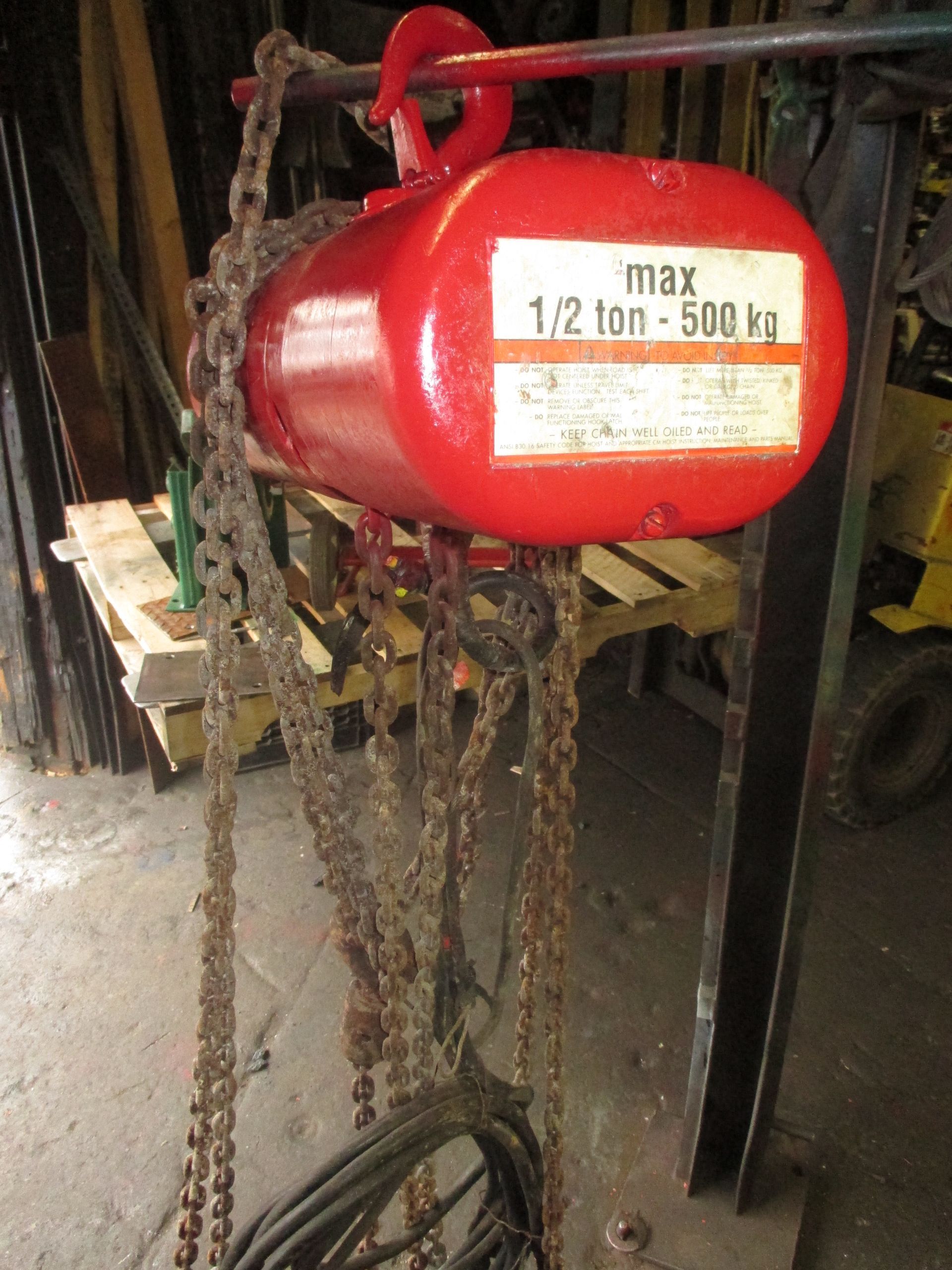 A red chain hoist with a max weight of 1.2 tons
