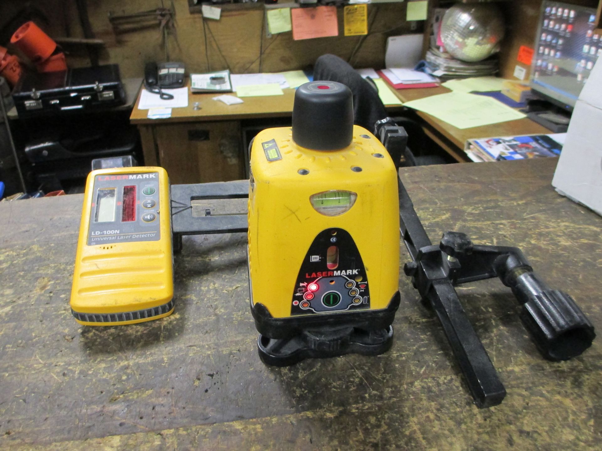 A yellow device with a level on it is on a table