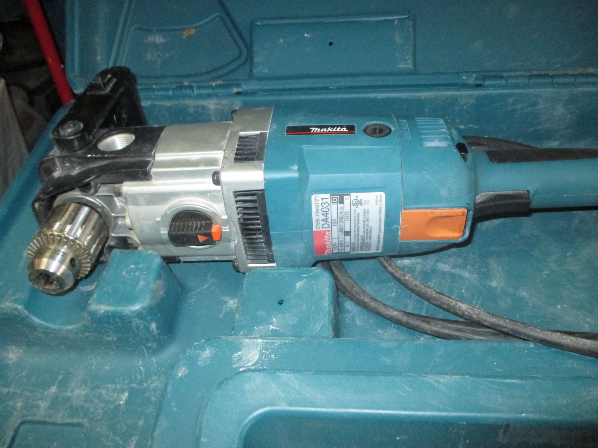 A drill is sitting inside of a blue case.