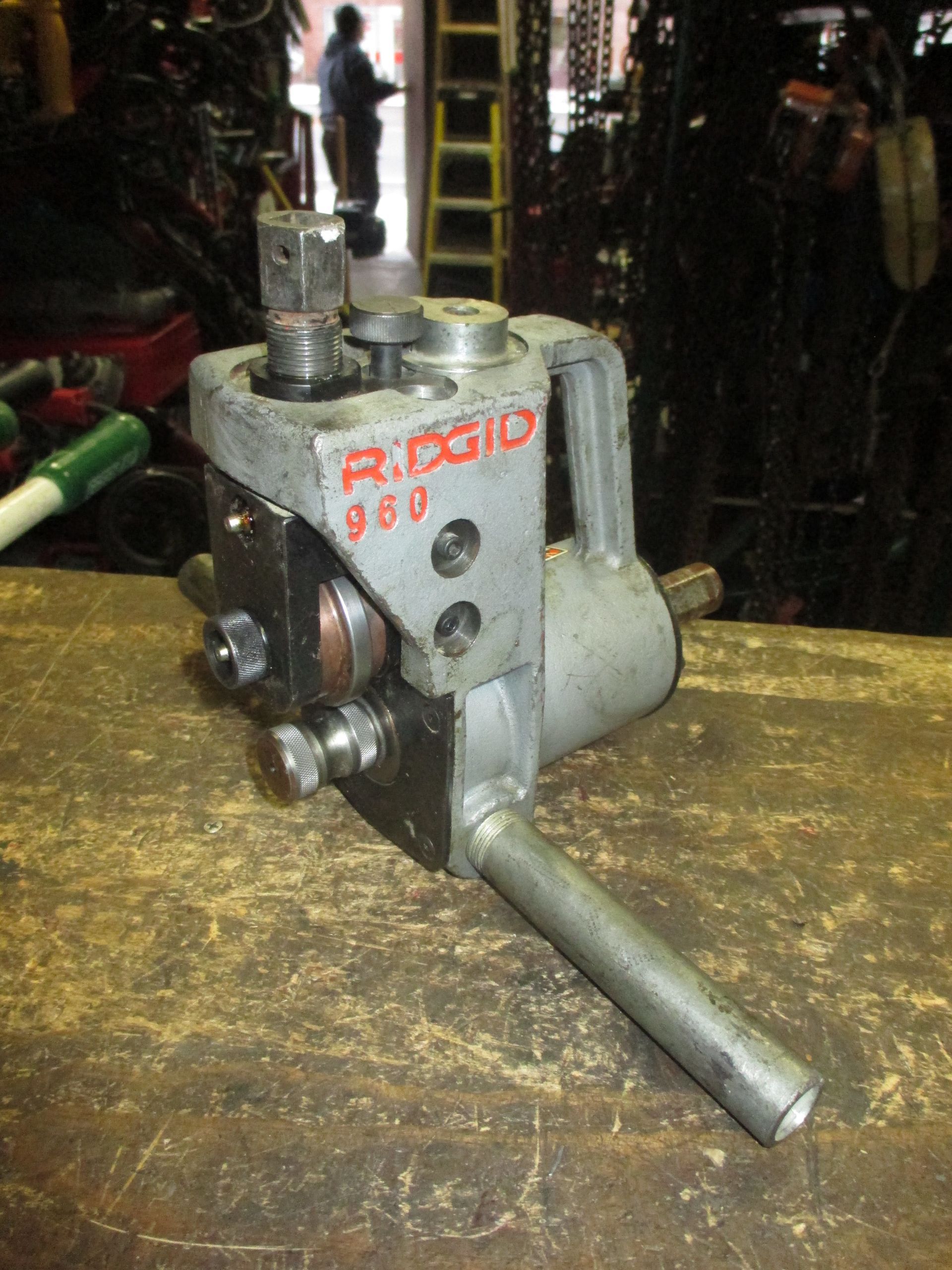 A rigid machine is sitting on a wooden table