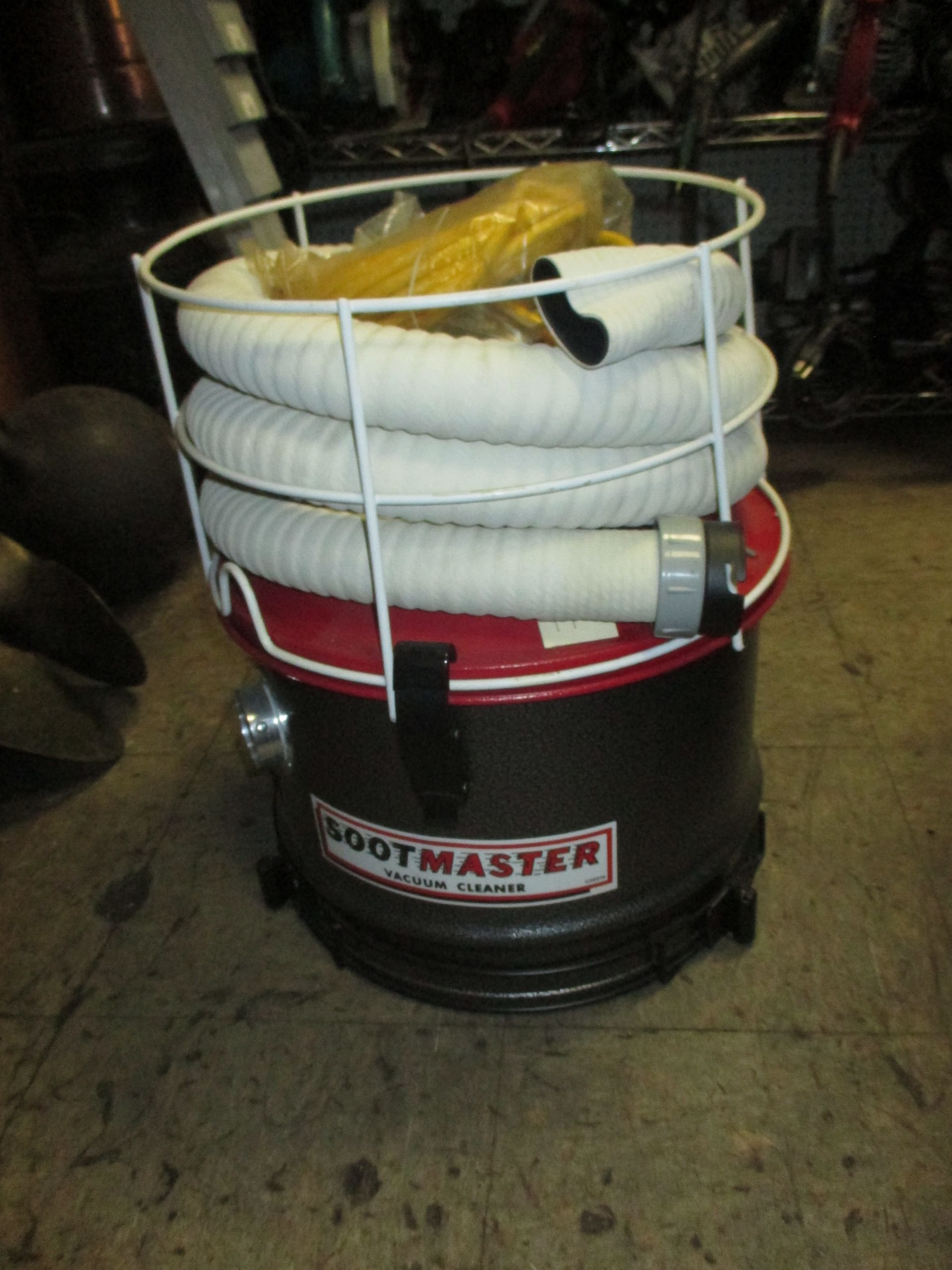 A bootmaster vacuum cleaner with a hose attached to it