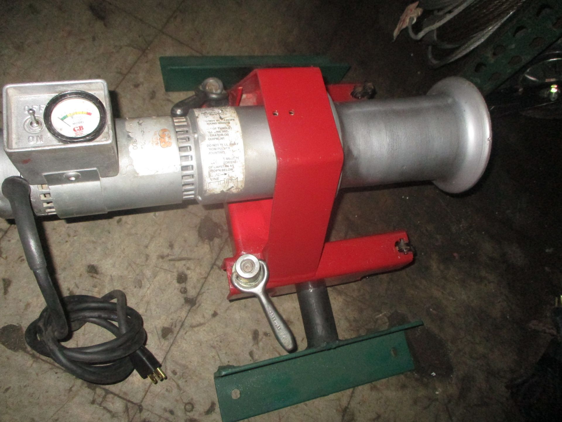 A red and silver machine with a wrench attached to it