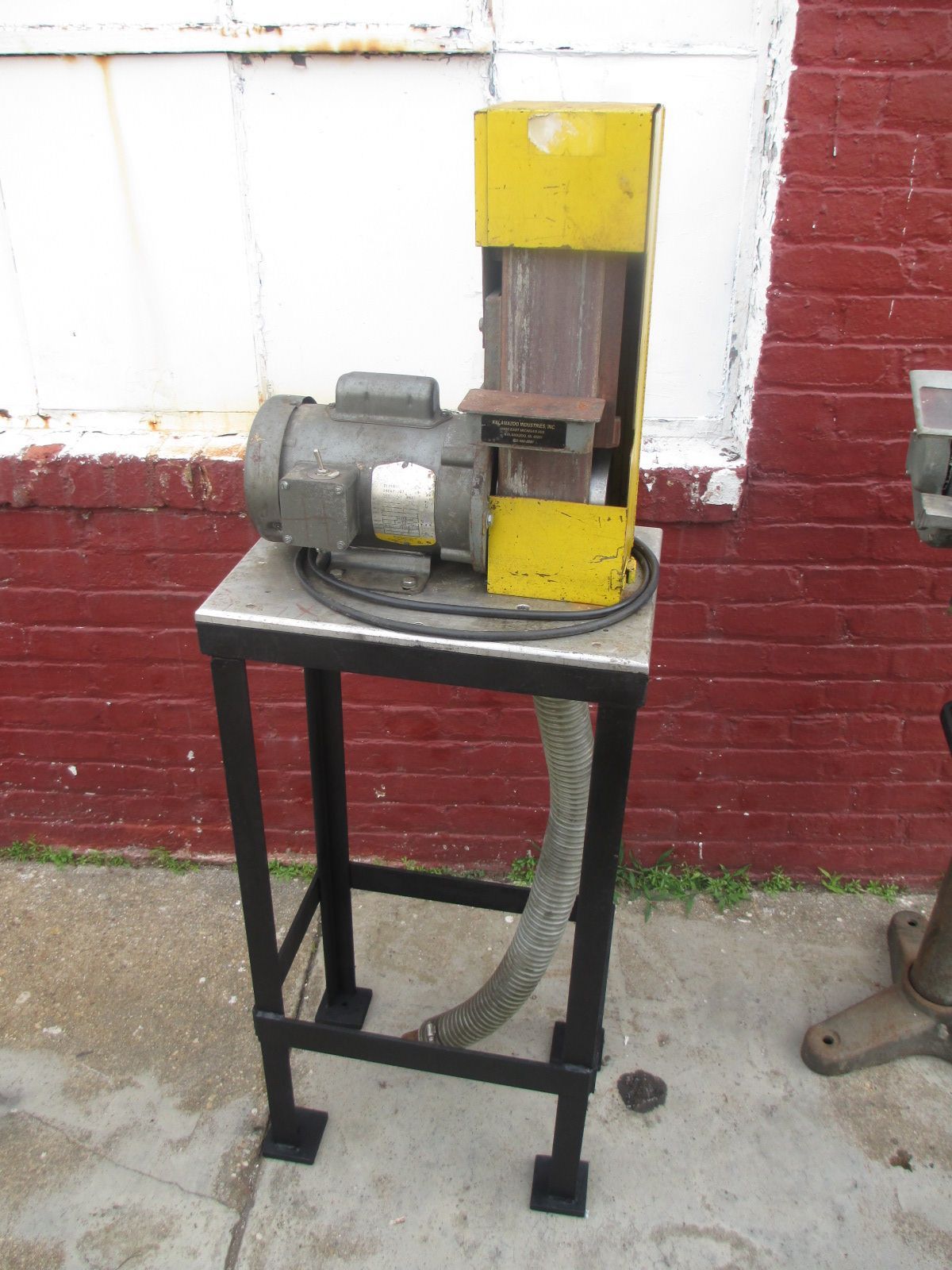 A machine is sitting on a table in front of a brick wall