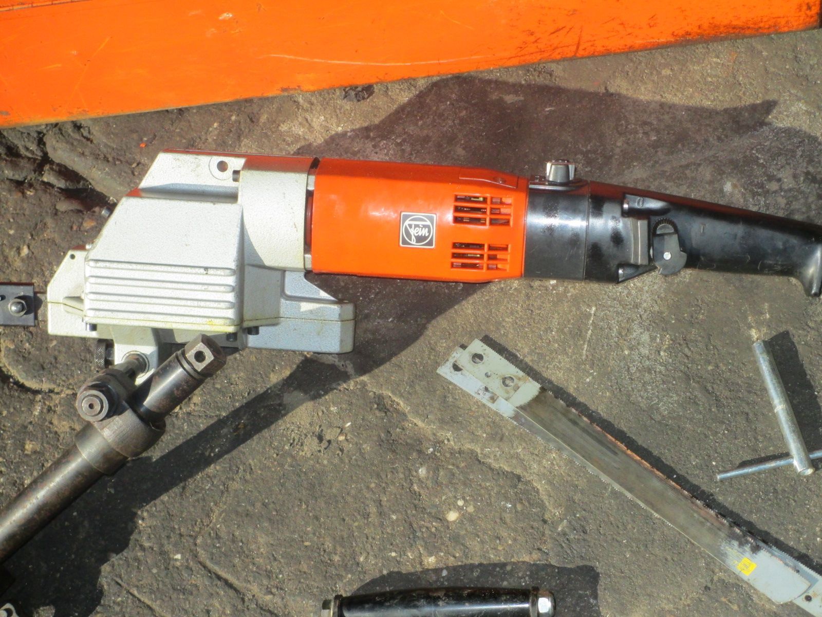 An orange and white tool with the number 10 on it