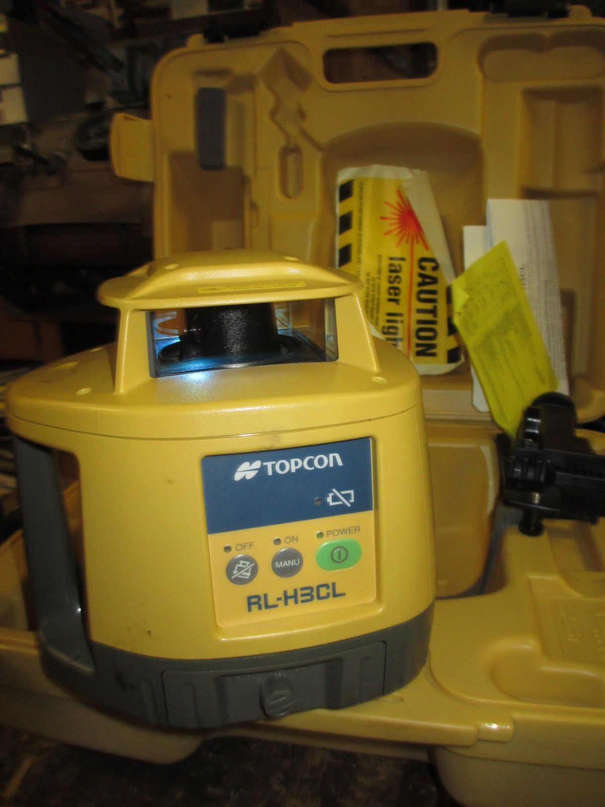 A tocon laser level is in a yellow case