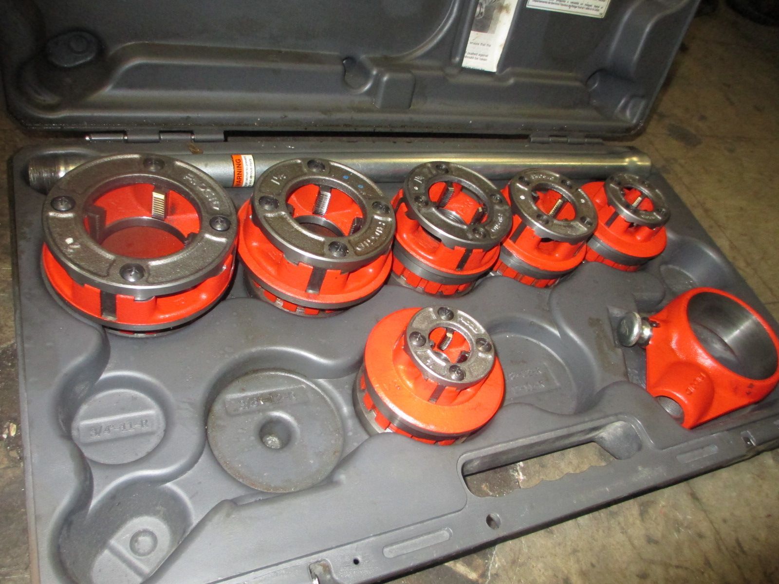 A set of red and black tools in a case