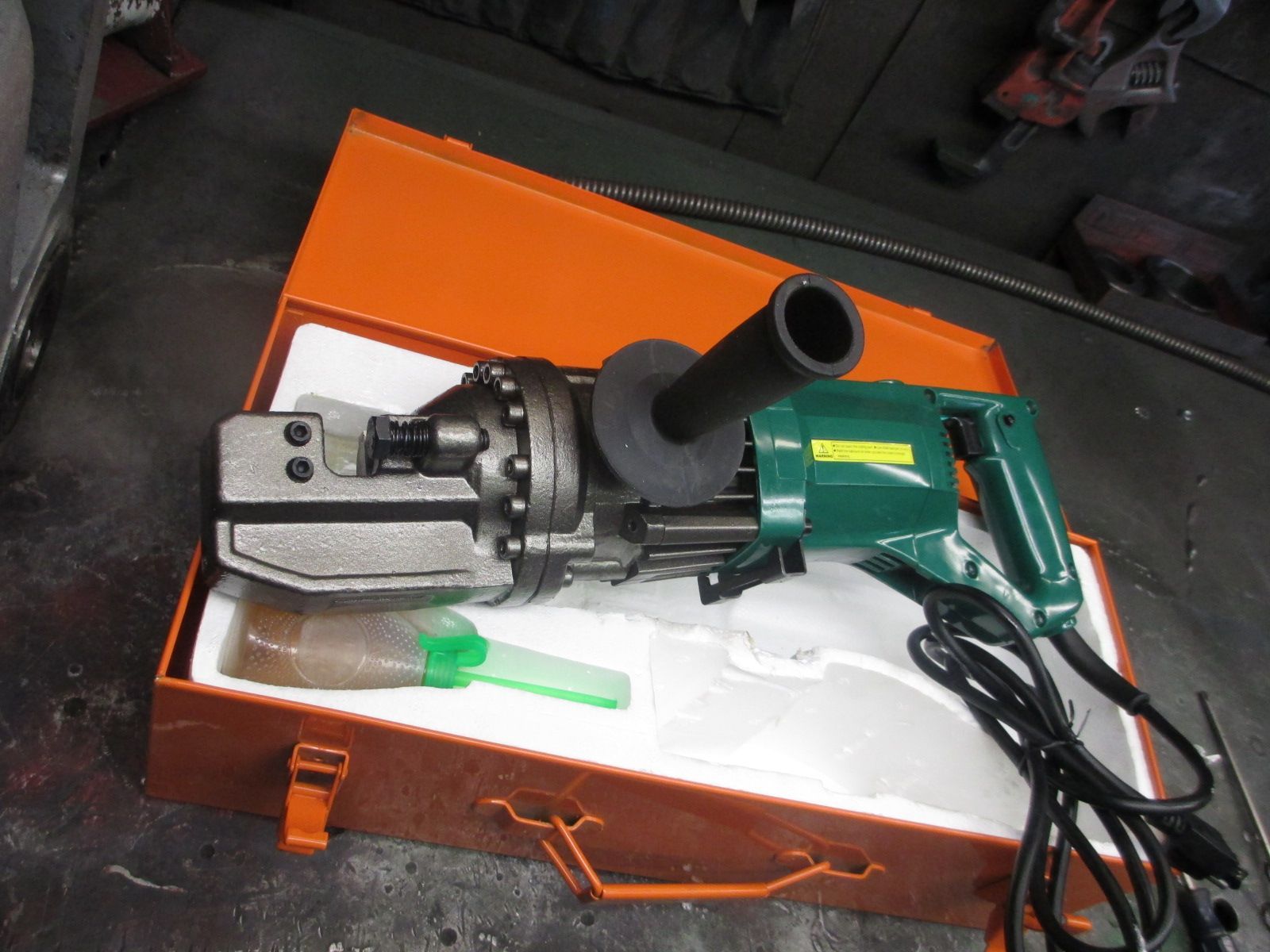 A green tool is sitting on top of an orange box