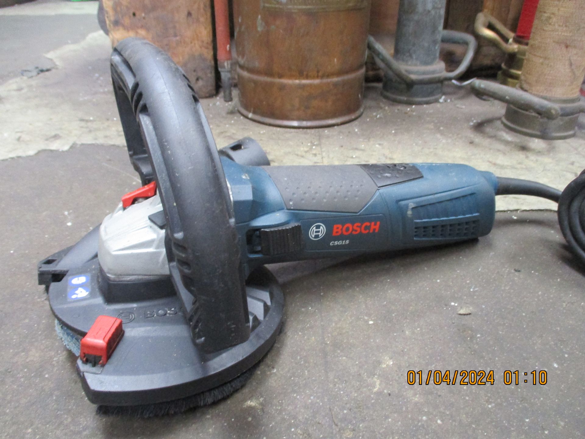 A bosch grinder is sitting on the ground