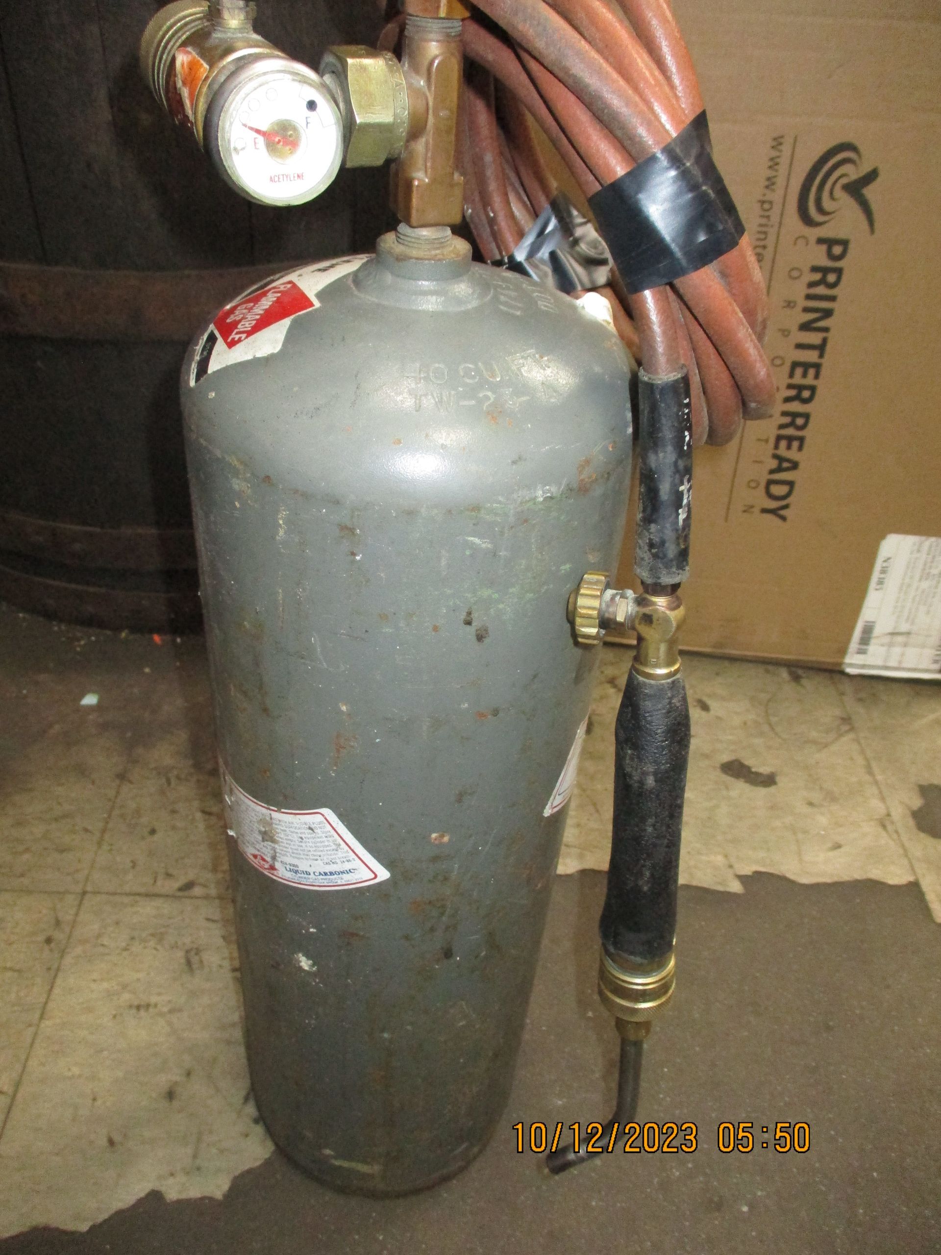 A printerready box sits next to a propane cylinder