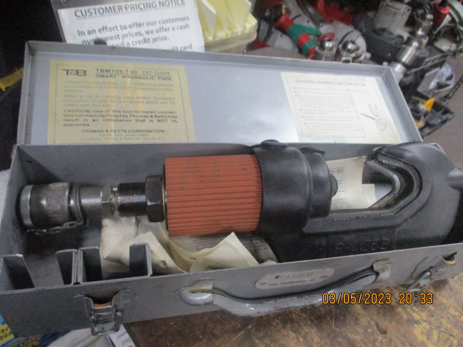 A tool is sitting in a briefcase on a table.