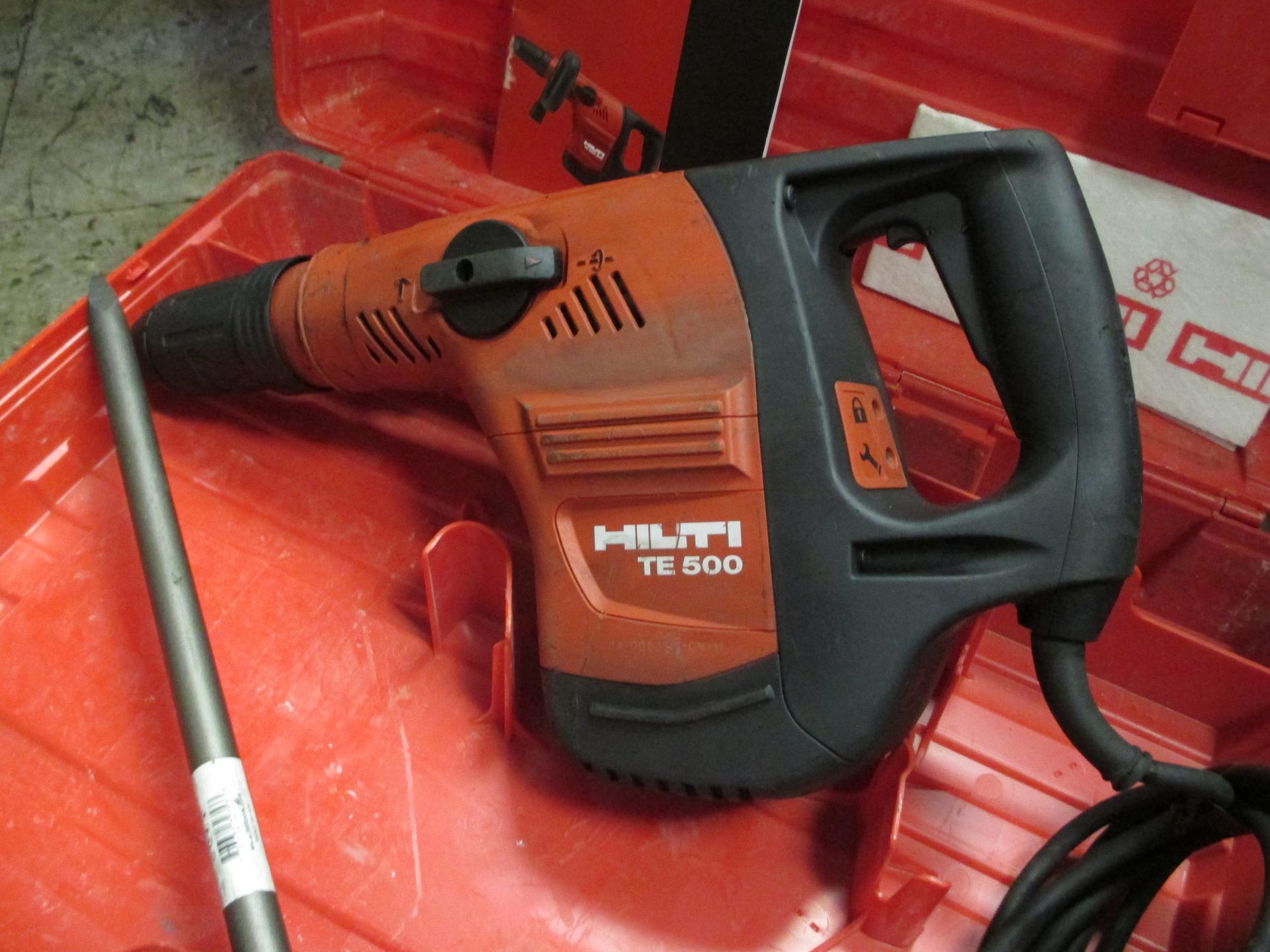 A hilti tc 500 hammer is sitting in a red case