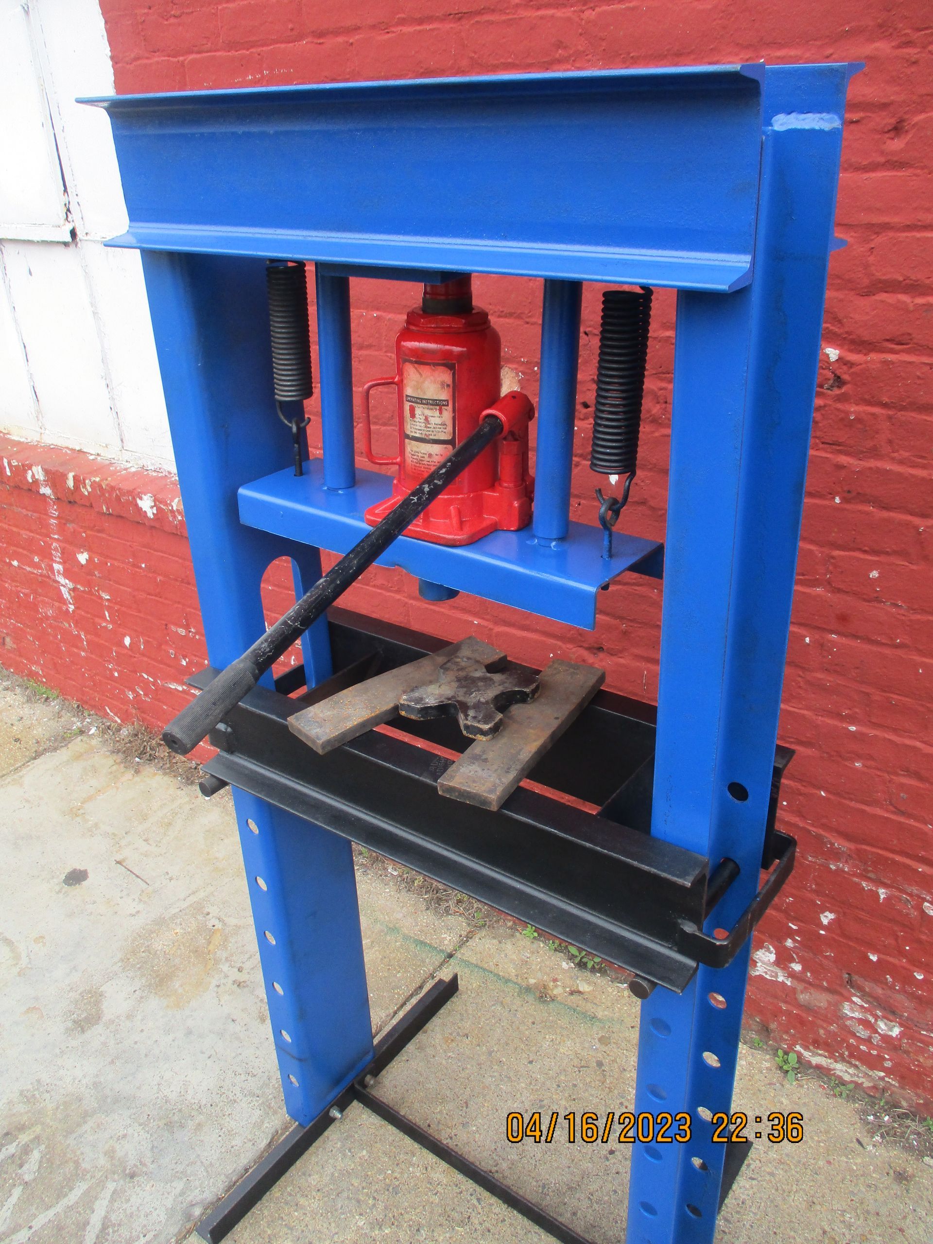 A blue machine with a red bottle on top of it