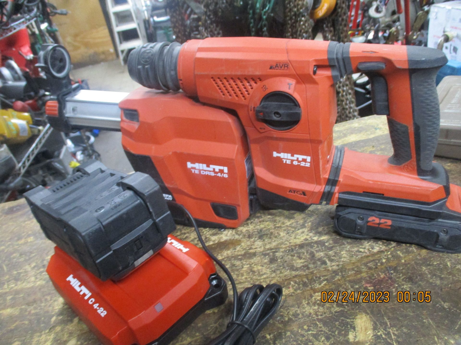 A red hammer drill with two batteries attached to it