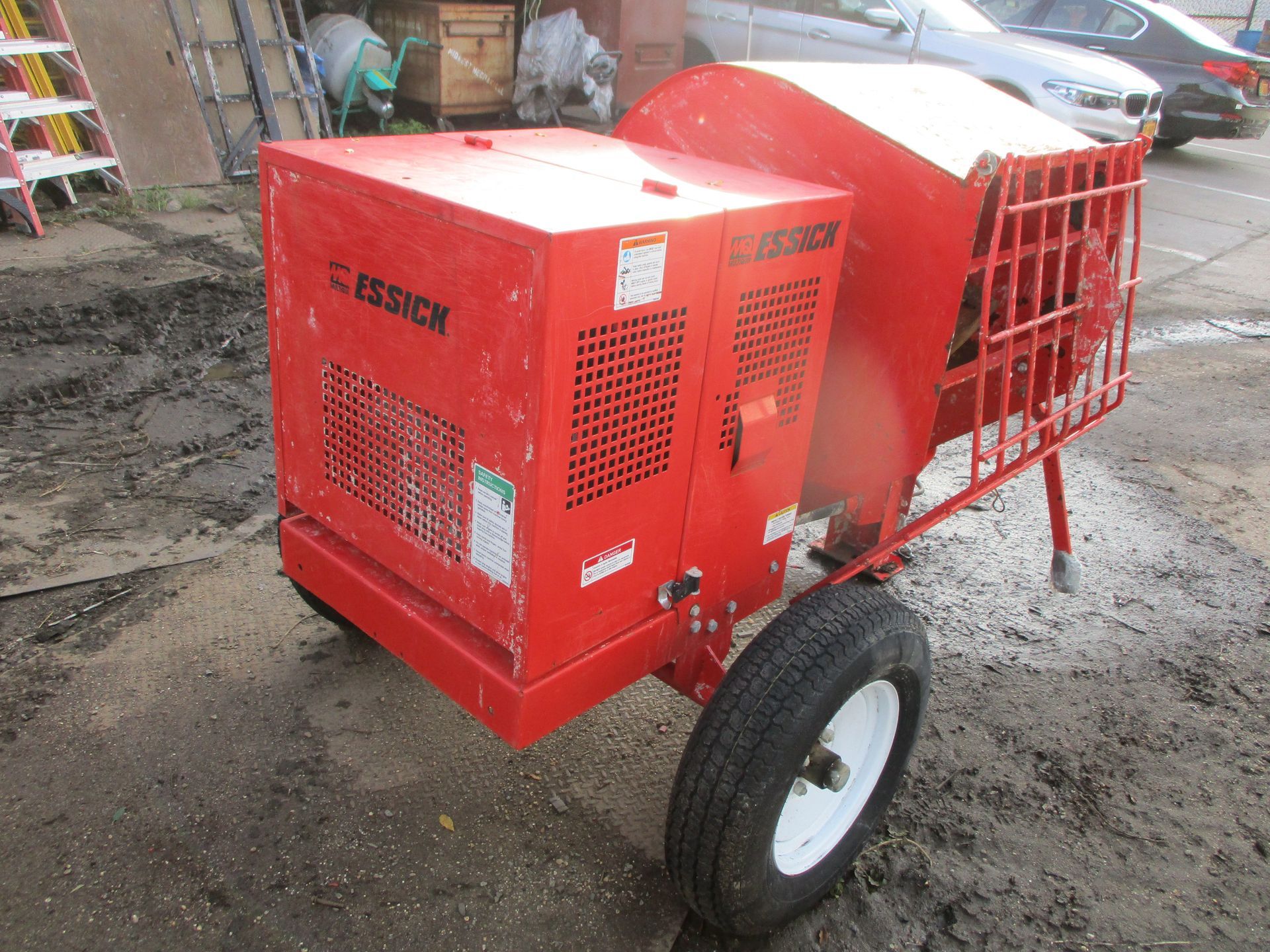 A red machine is parked on the side of the road